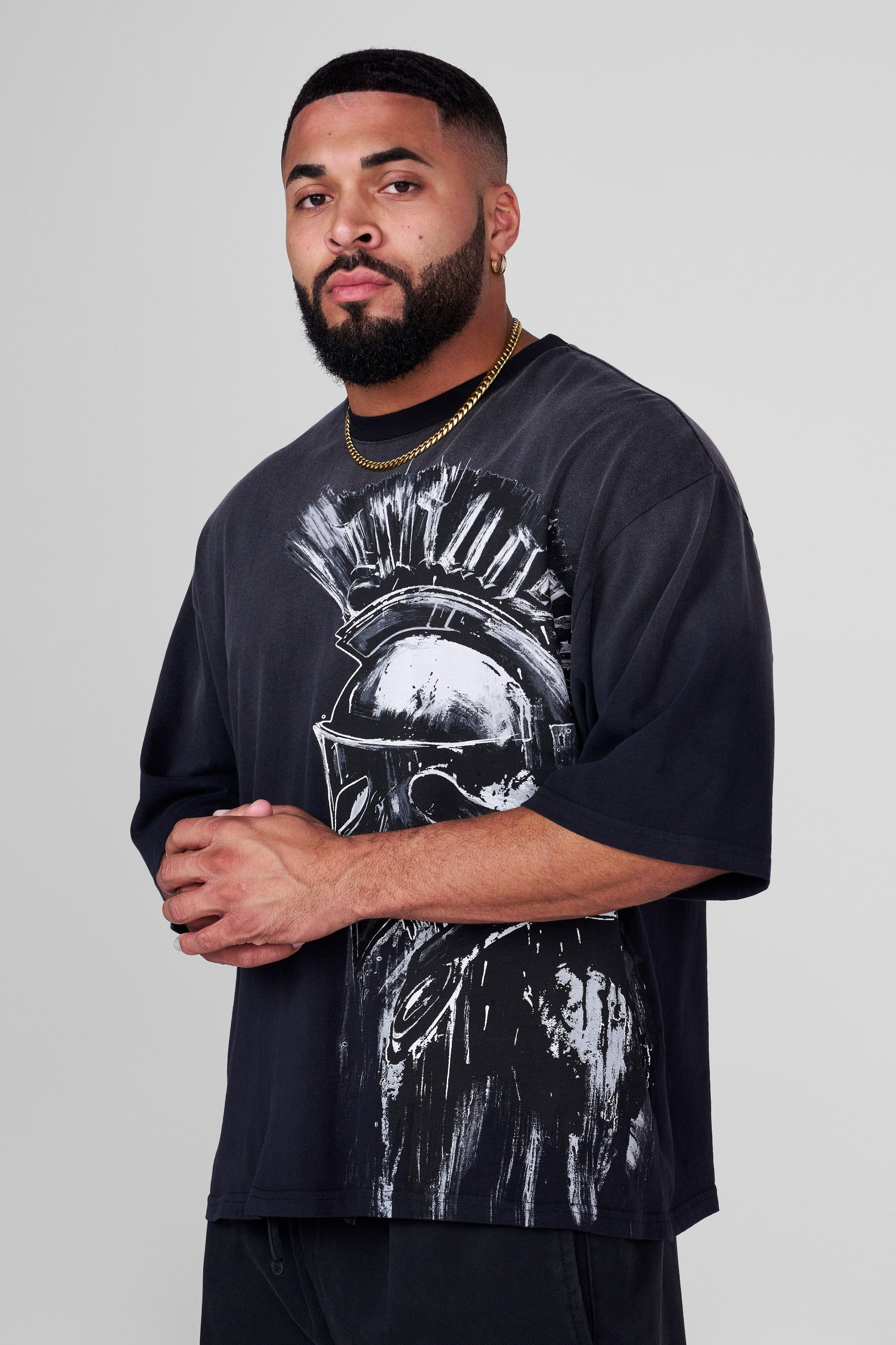 Side angle of the oversized Spartan tee highlighting the relaxed fit.