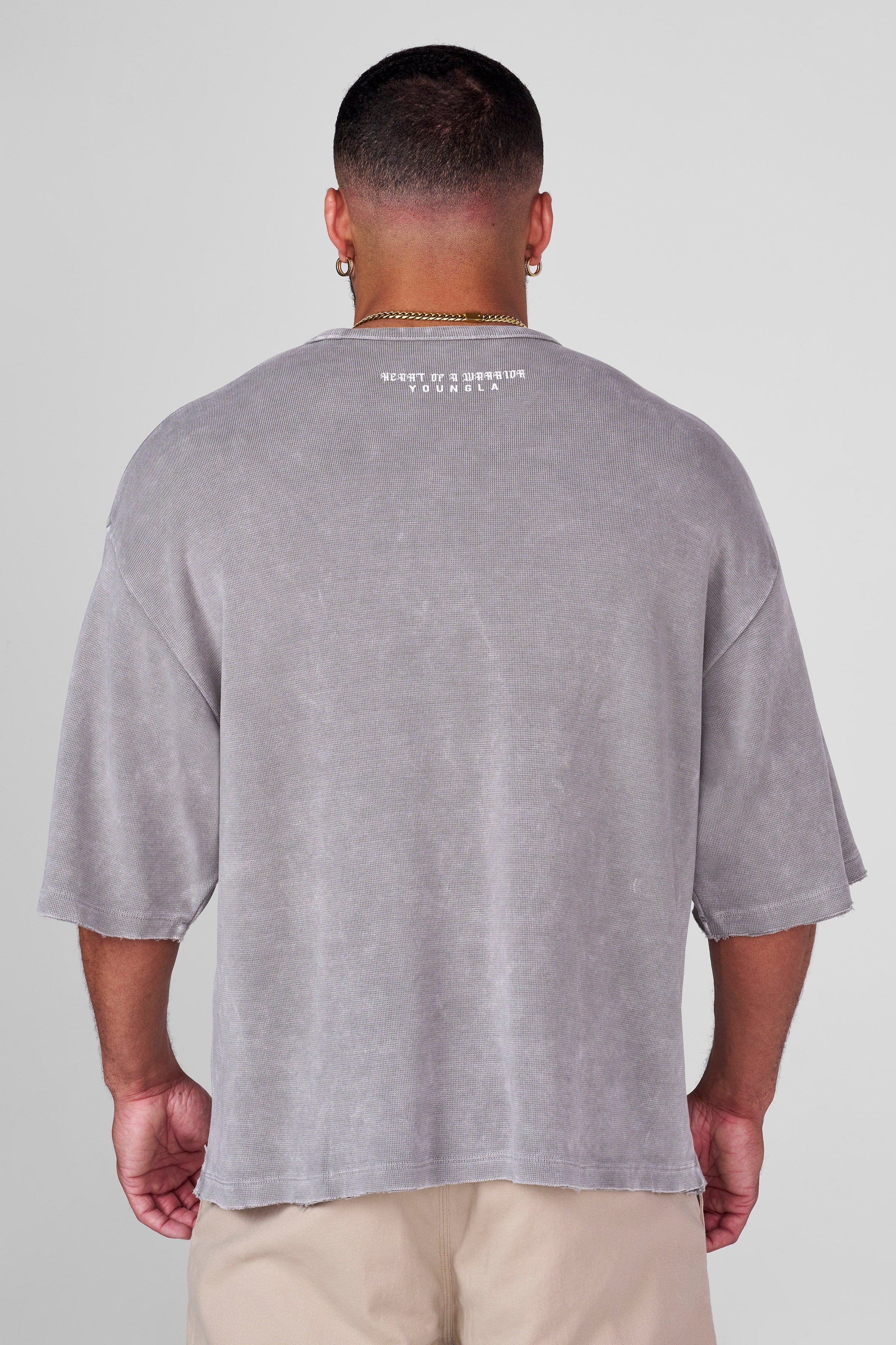 Side angle of vintage t-shirt with relaxed fit and worn texture