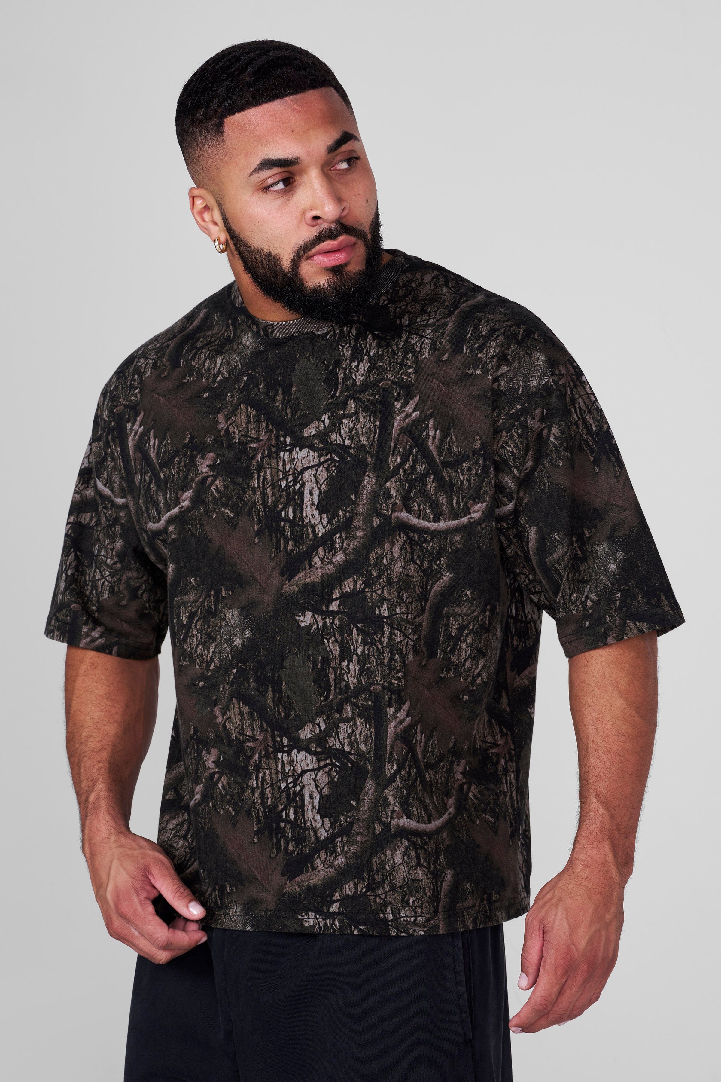Front view of oversized t shirt men in natural setting showing relaxed fit