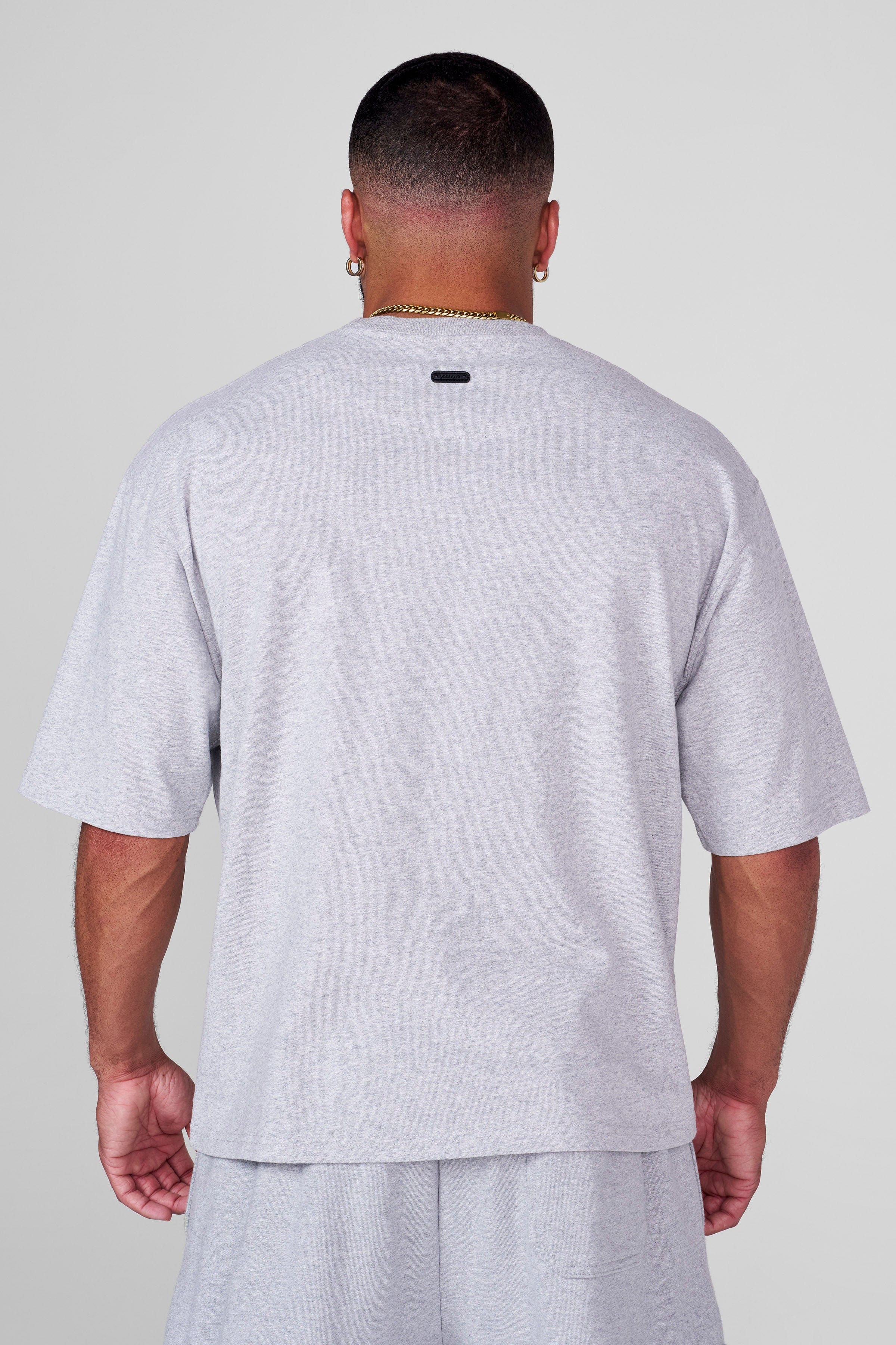 Back view highlighting subtle metal logo tag on heritage shirt