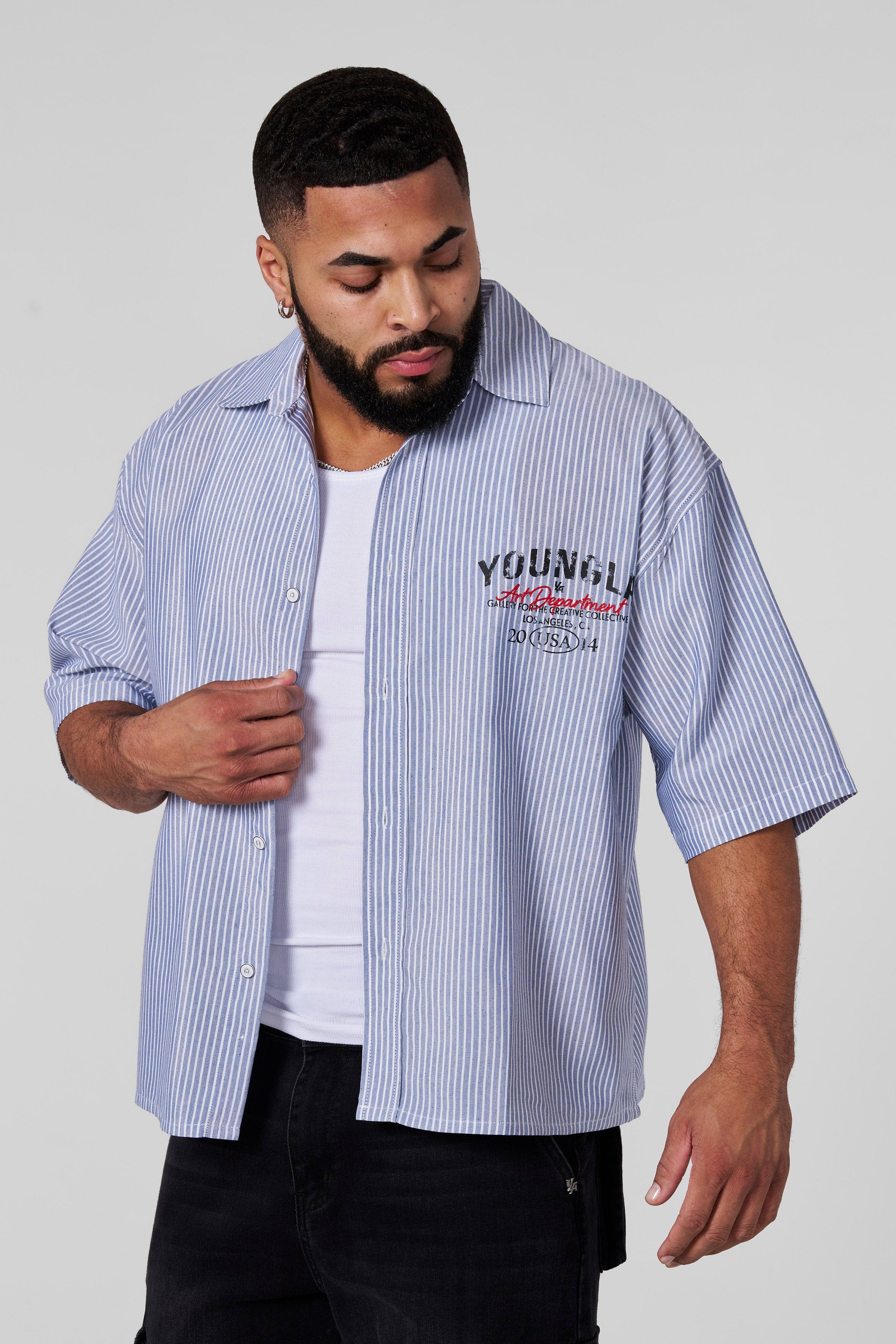 Side angle of a mens button up black shirt showcasing its relaxed fit and breathable fabric.