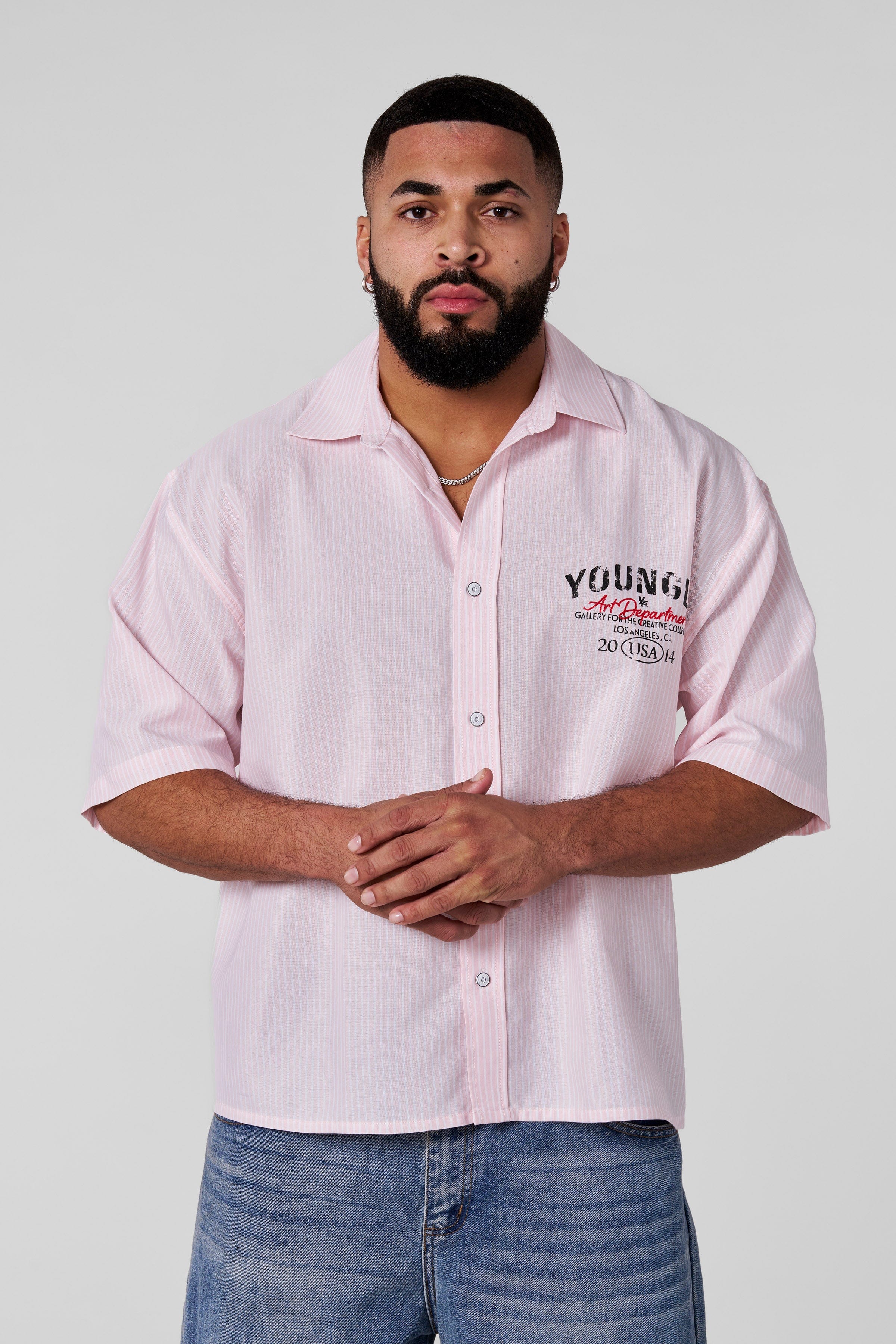 Side angle of a mens button up black shirt showcasing its relaxed fit and breathable fabric.