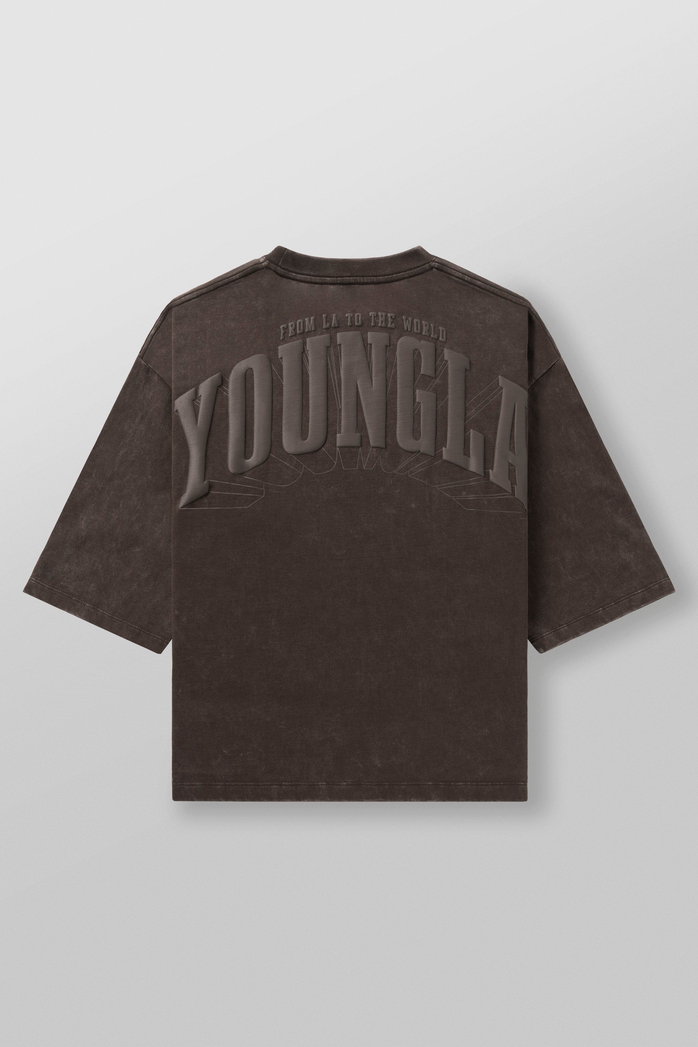 Detail shot showing the tee’s cropped hemline and loose fit