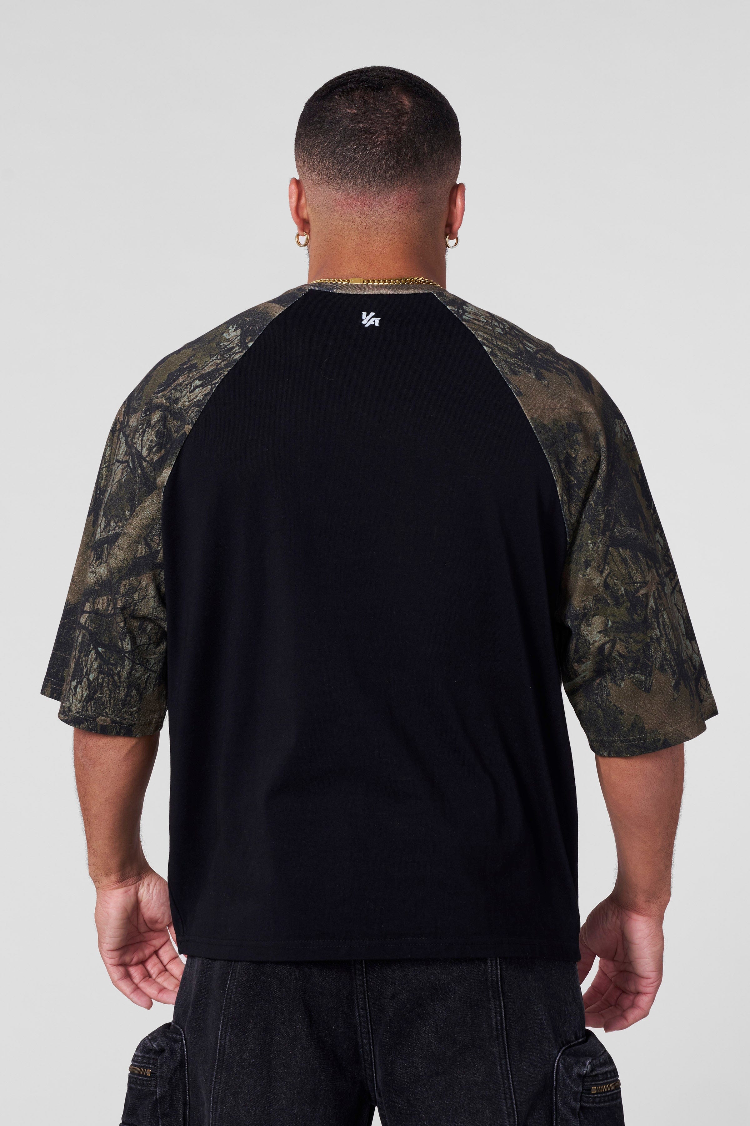 Side view showcasing the contrasting raglan sleeves of the oversized t shirt.