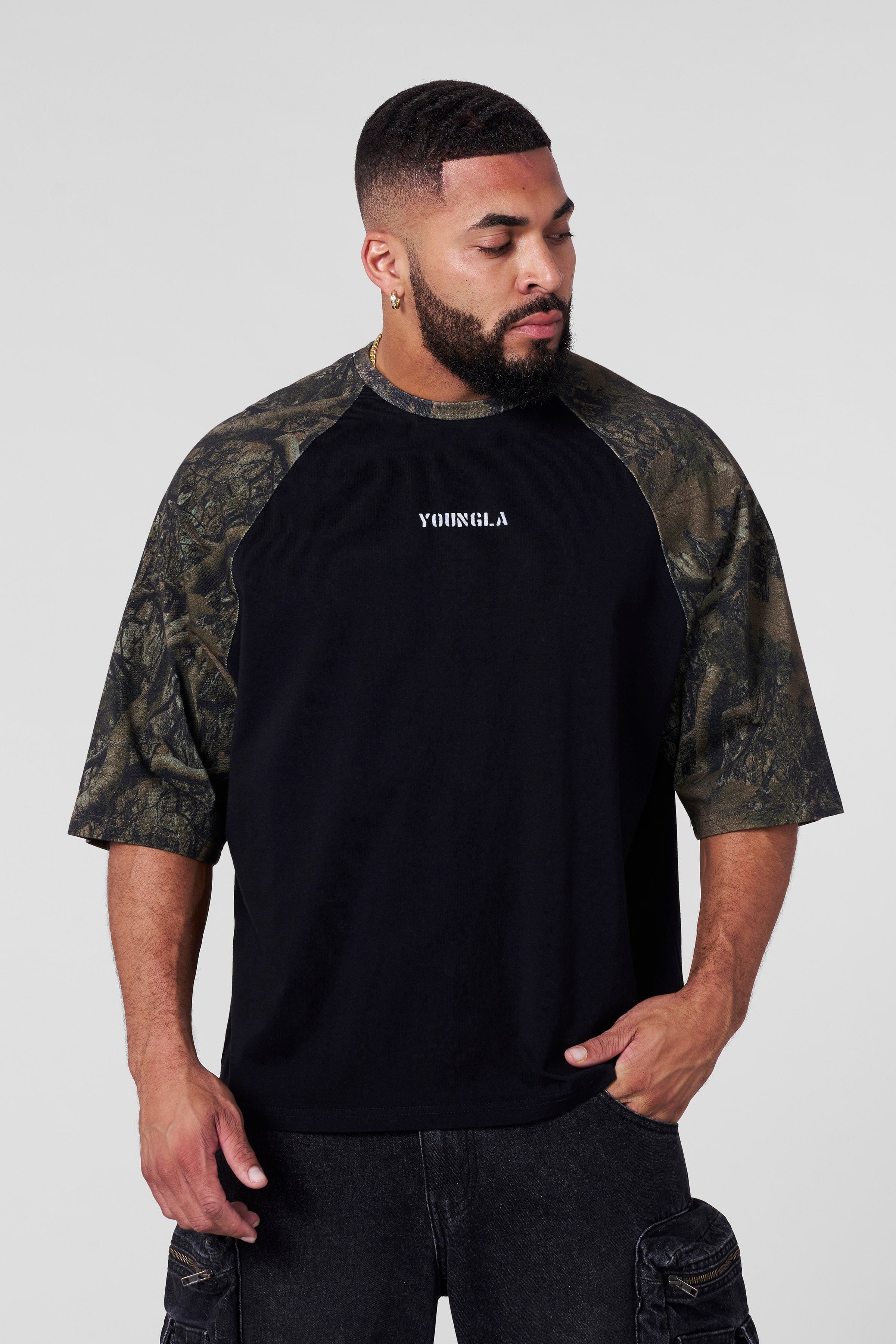 Front view of mens oversized baseball tee in black with vintage design.