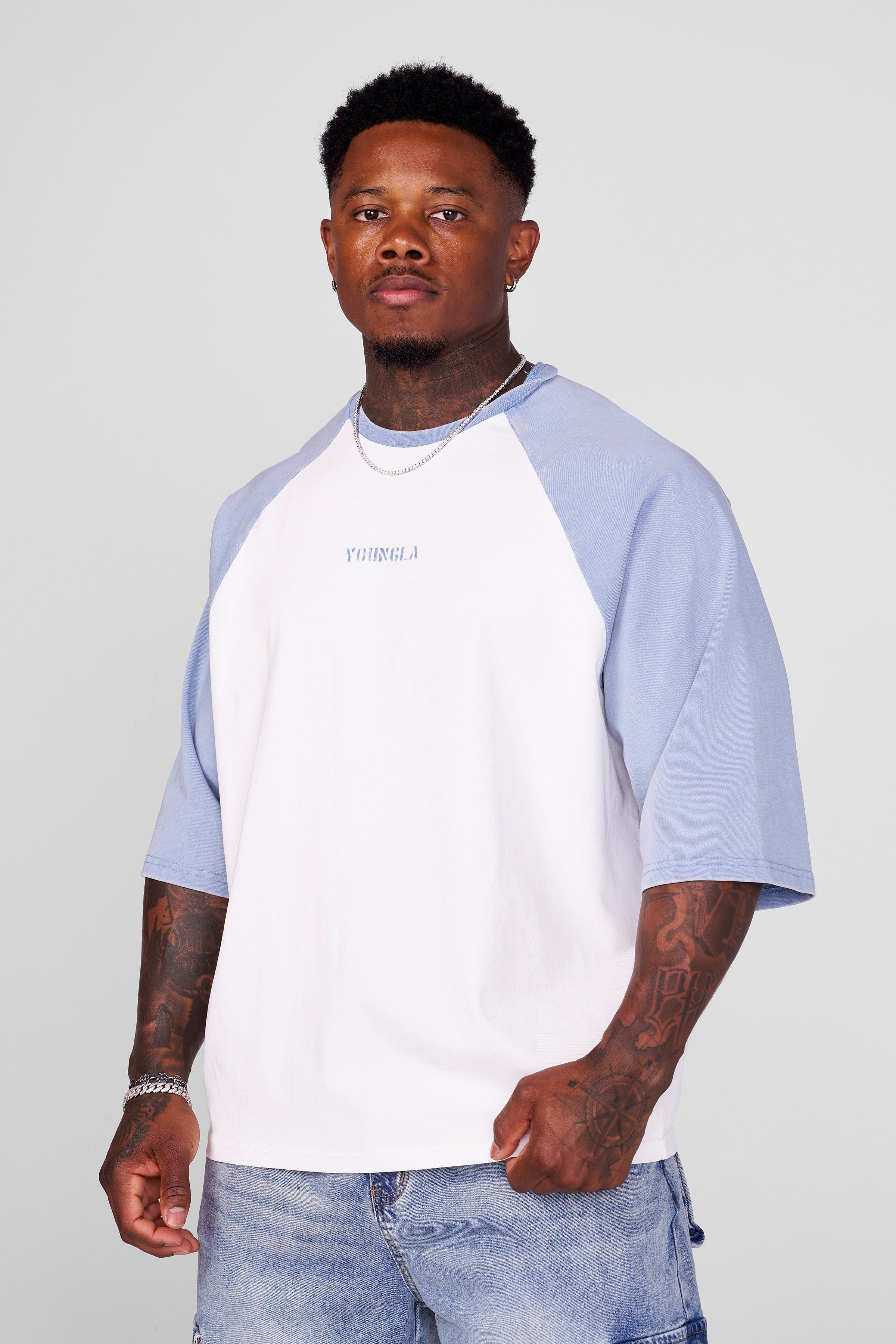 Side view showcasing the contrasting raglan sleeves of the oversized t shirt.