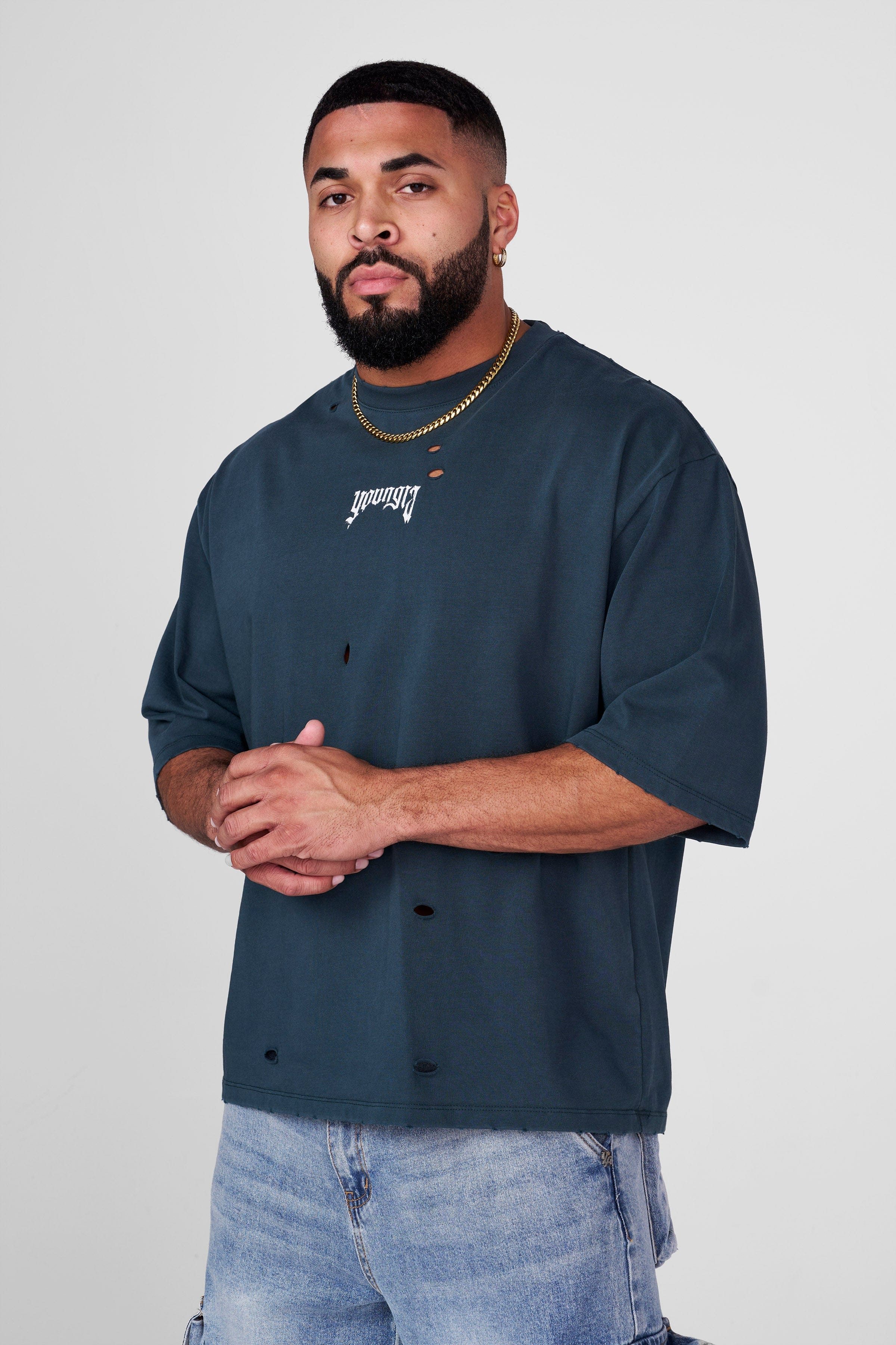 Side view of model wearing oversized t shirt men version with ripped detailing