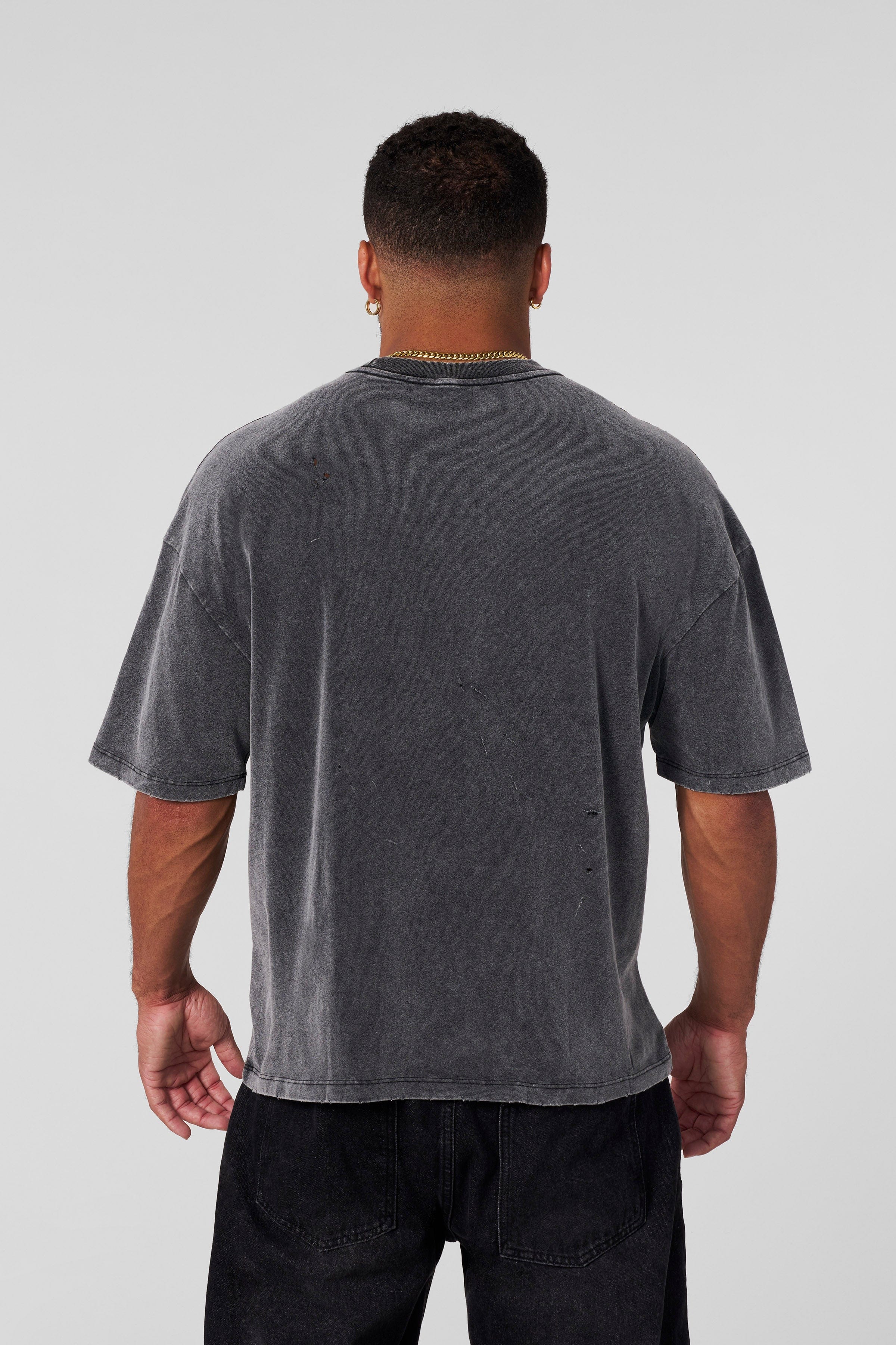 Side view of model wearing scuffed cloud graphic t-shirt