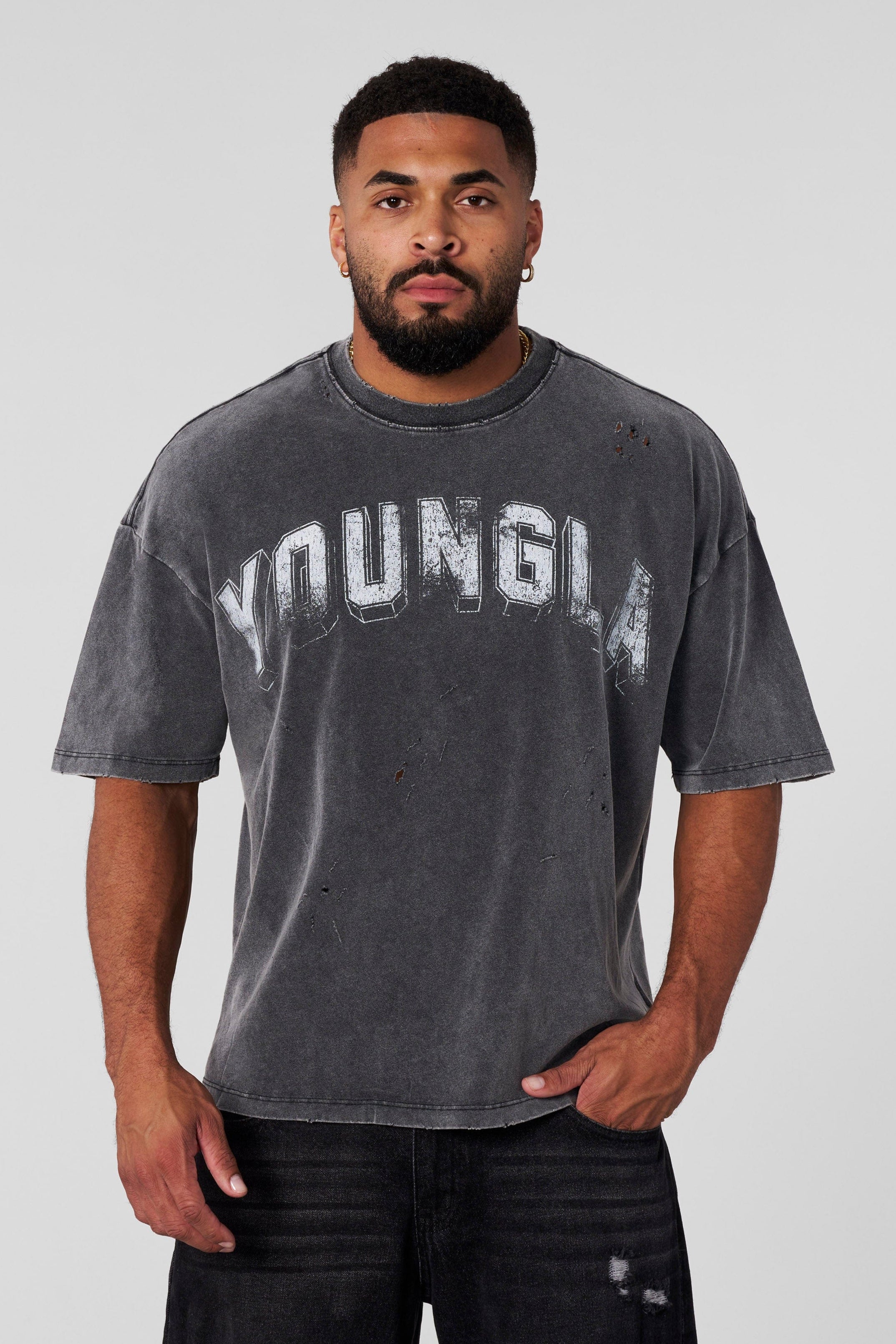 Close-up of vintage t shirt’s distressed cuts and arched logo