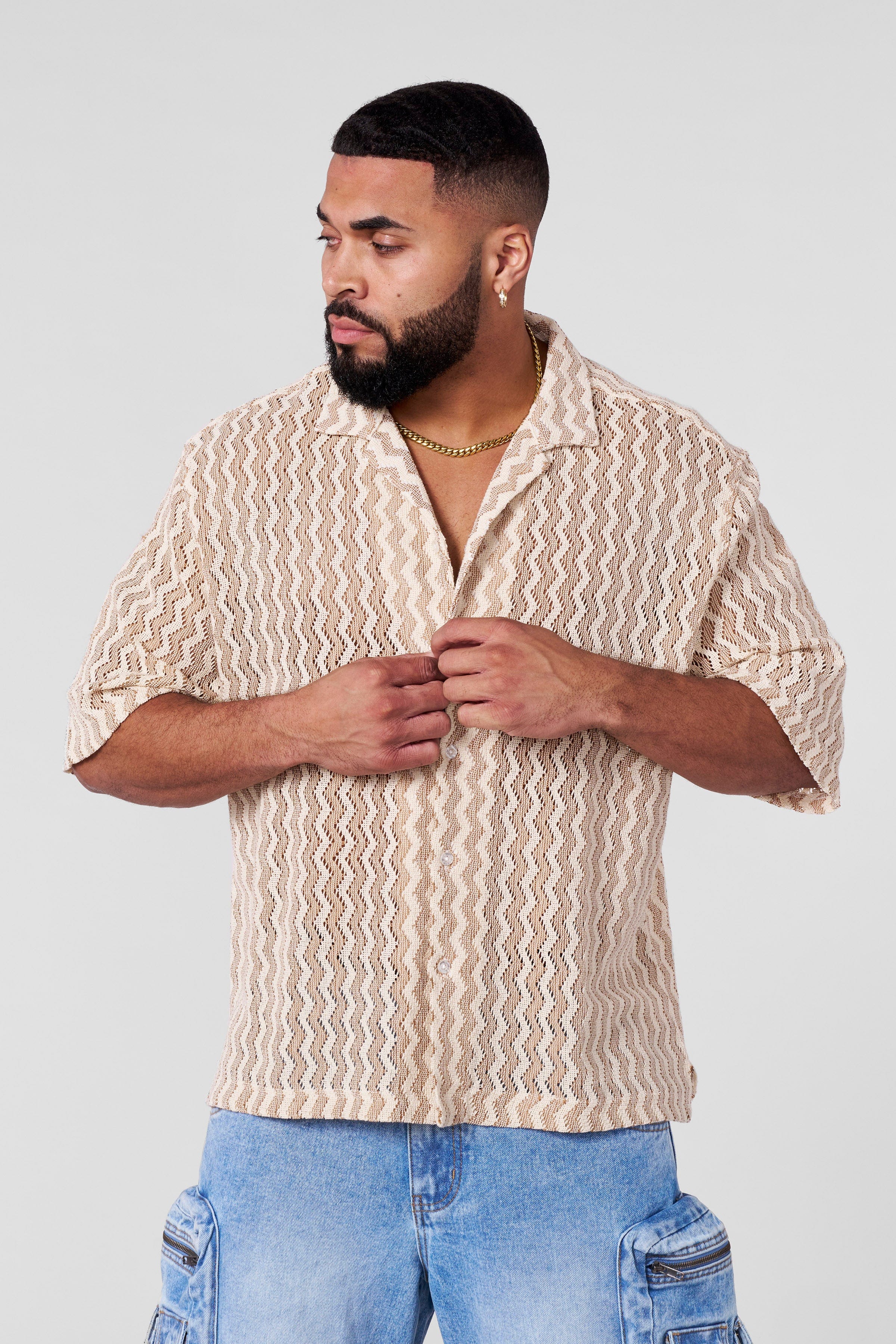 Stylish summer shirt folded on wooden surface