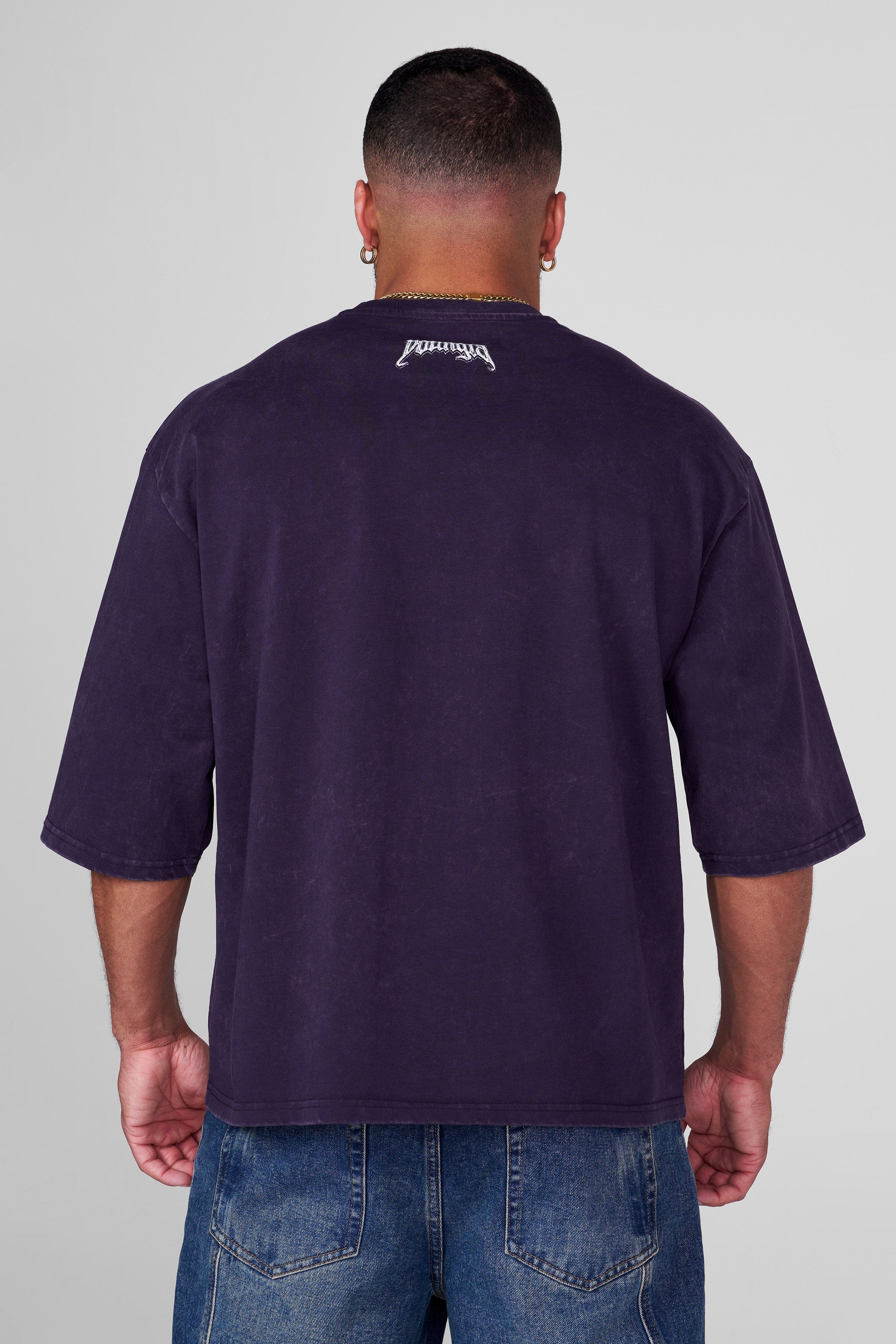 Side angle of oversized t shirt women styled with jeans, highlighting relaxed drape.