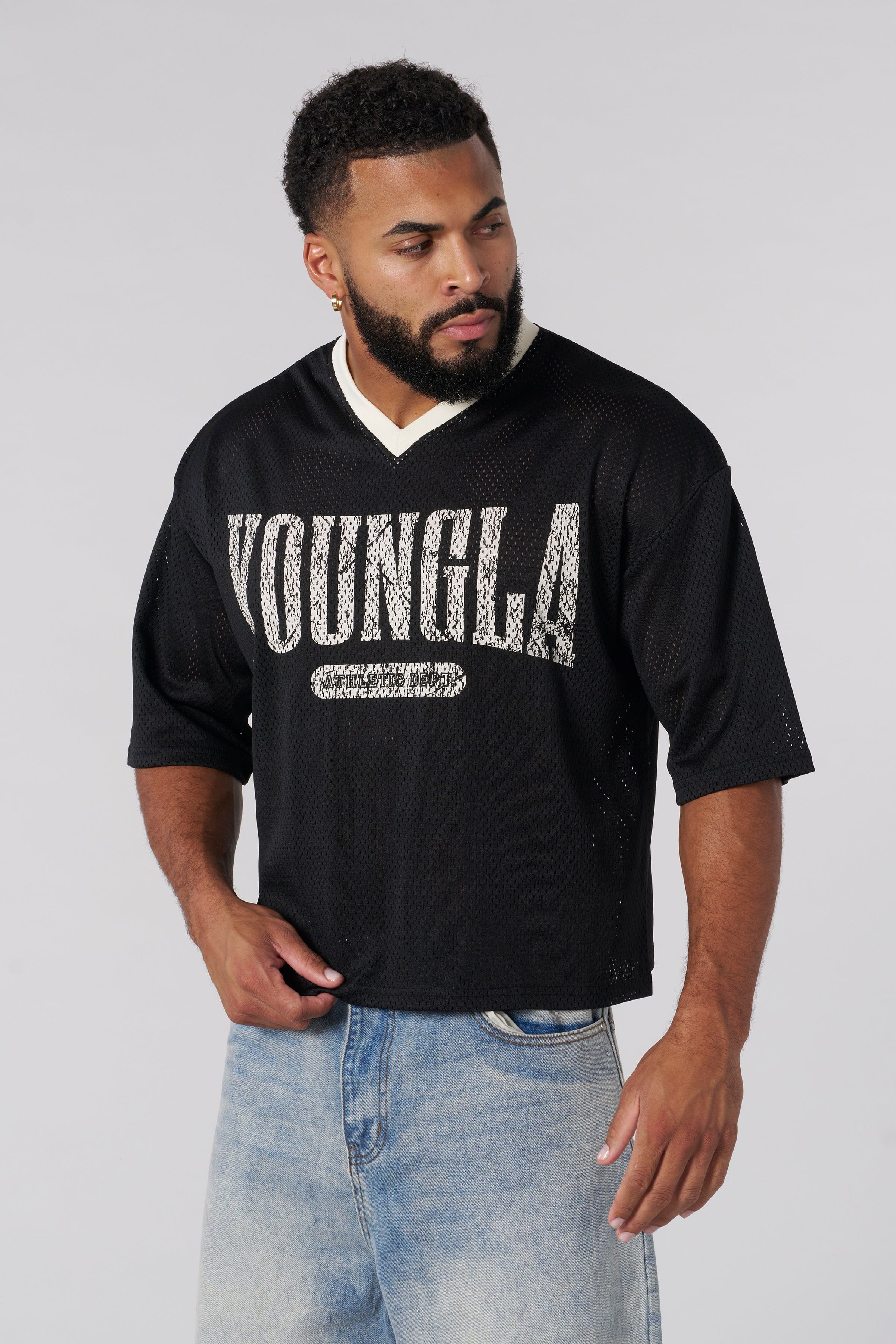 Front view of varsity football cropped jersey with ribbed V-neck and distressed logo