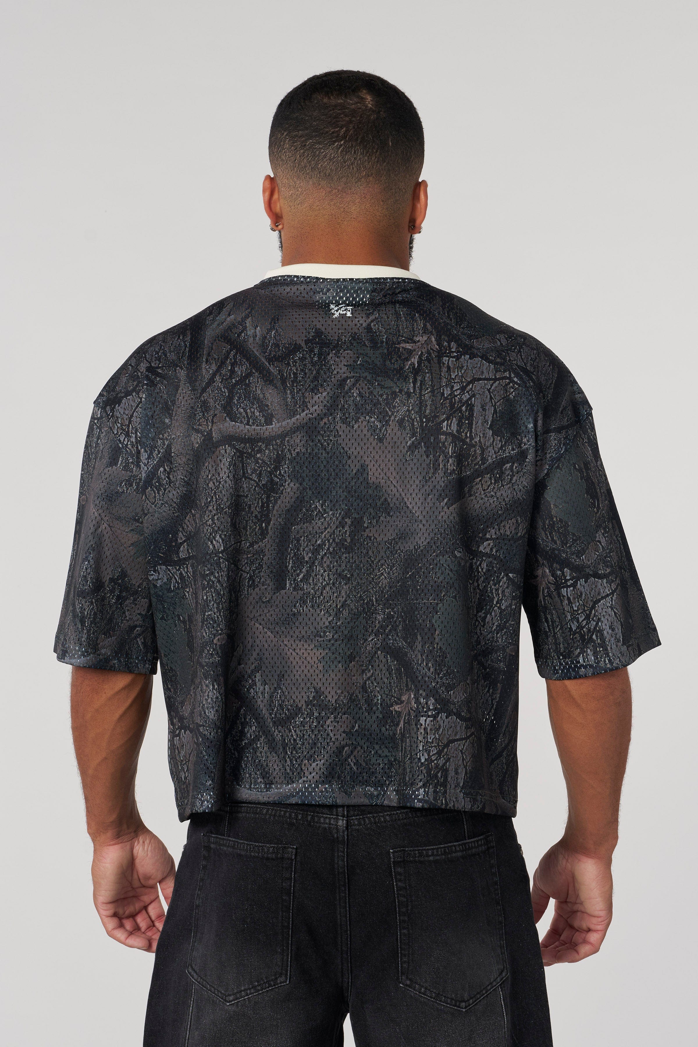 Front view of varsity football cropped jersey with ribbed V-neck and distressed logo