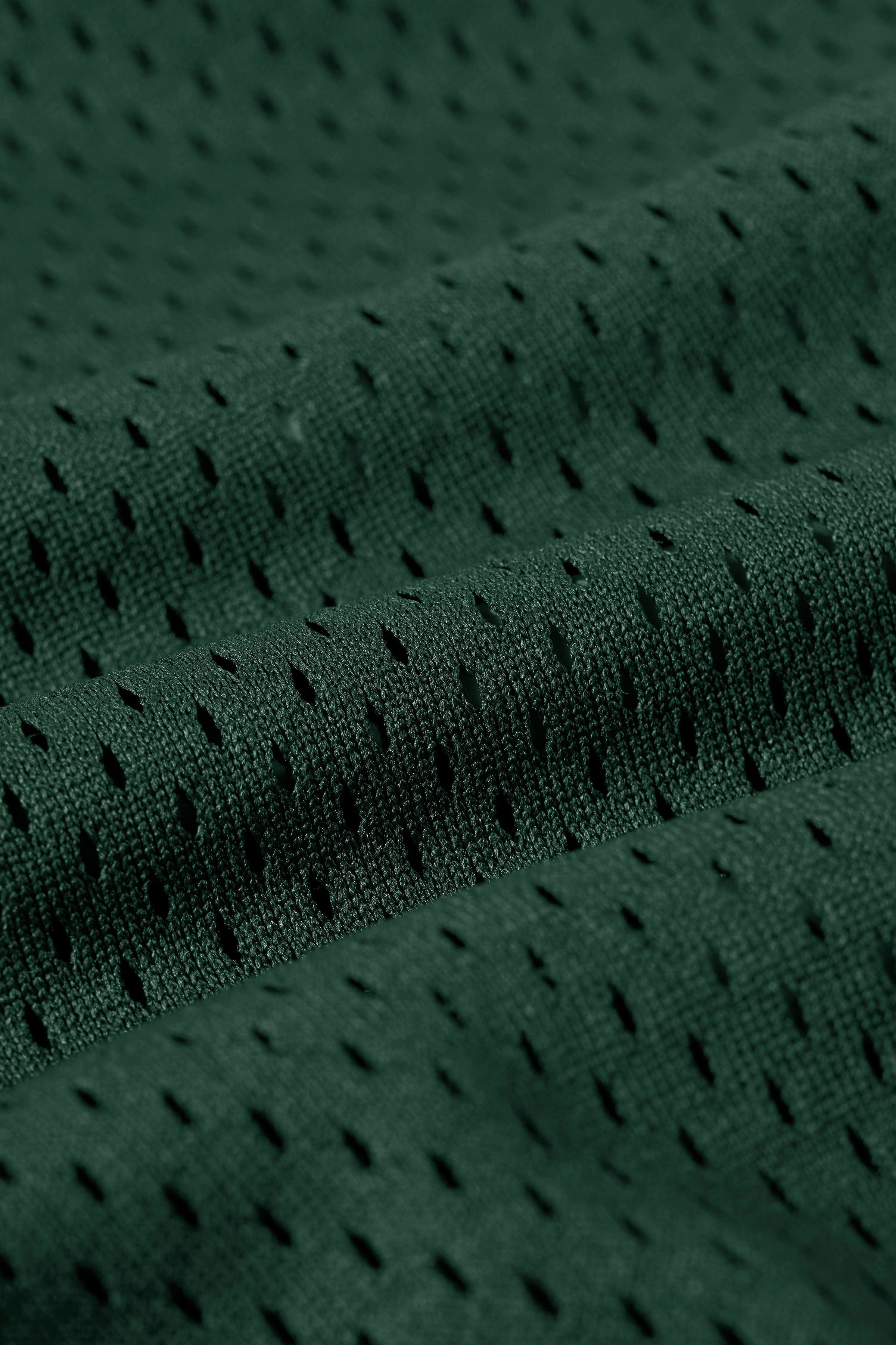 Close-up of the polyester mesh fabric and logo detail on the jersey
