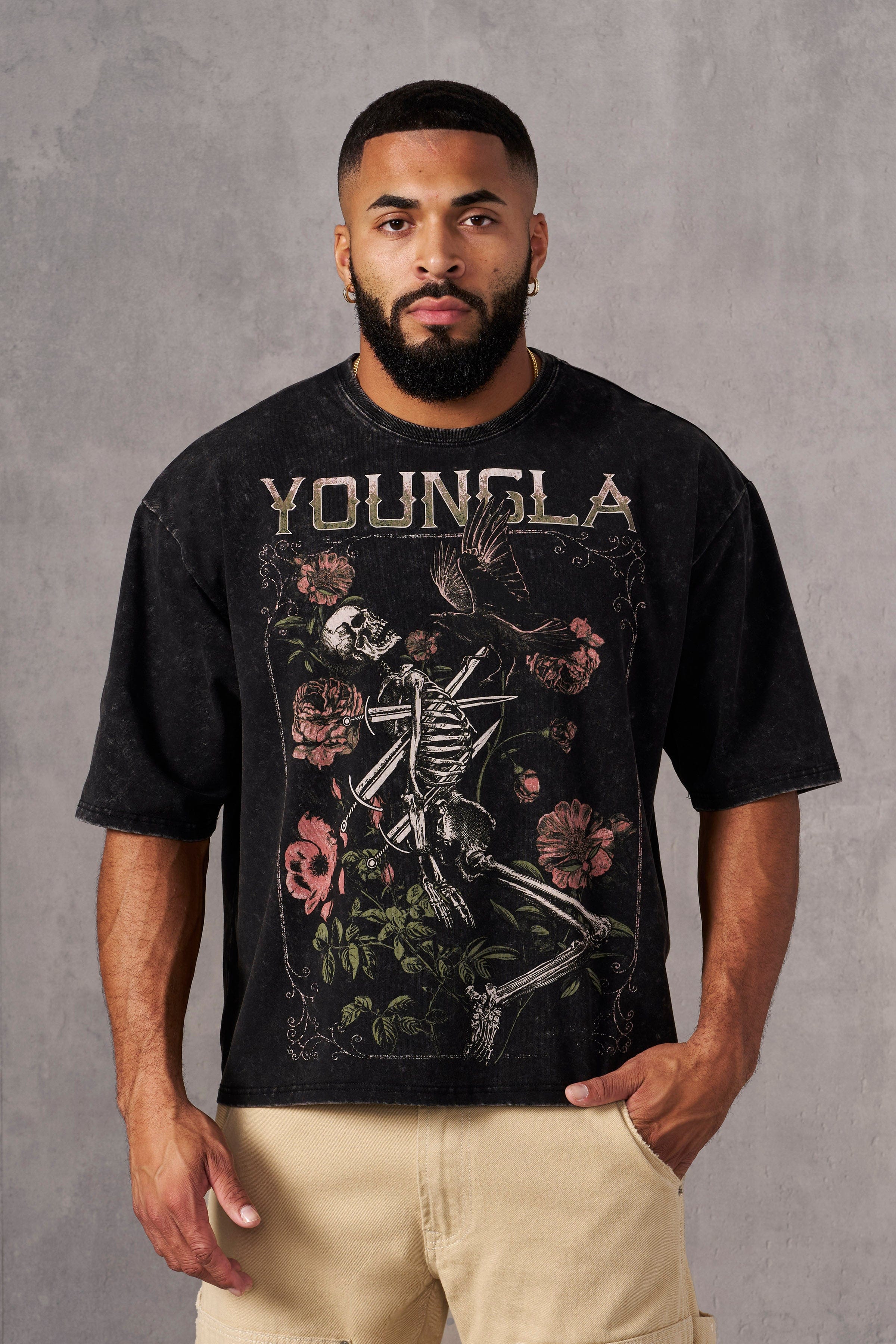 Back angle of graphic t-shirt styled with layered accessories