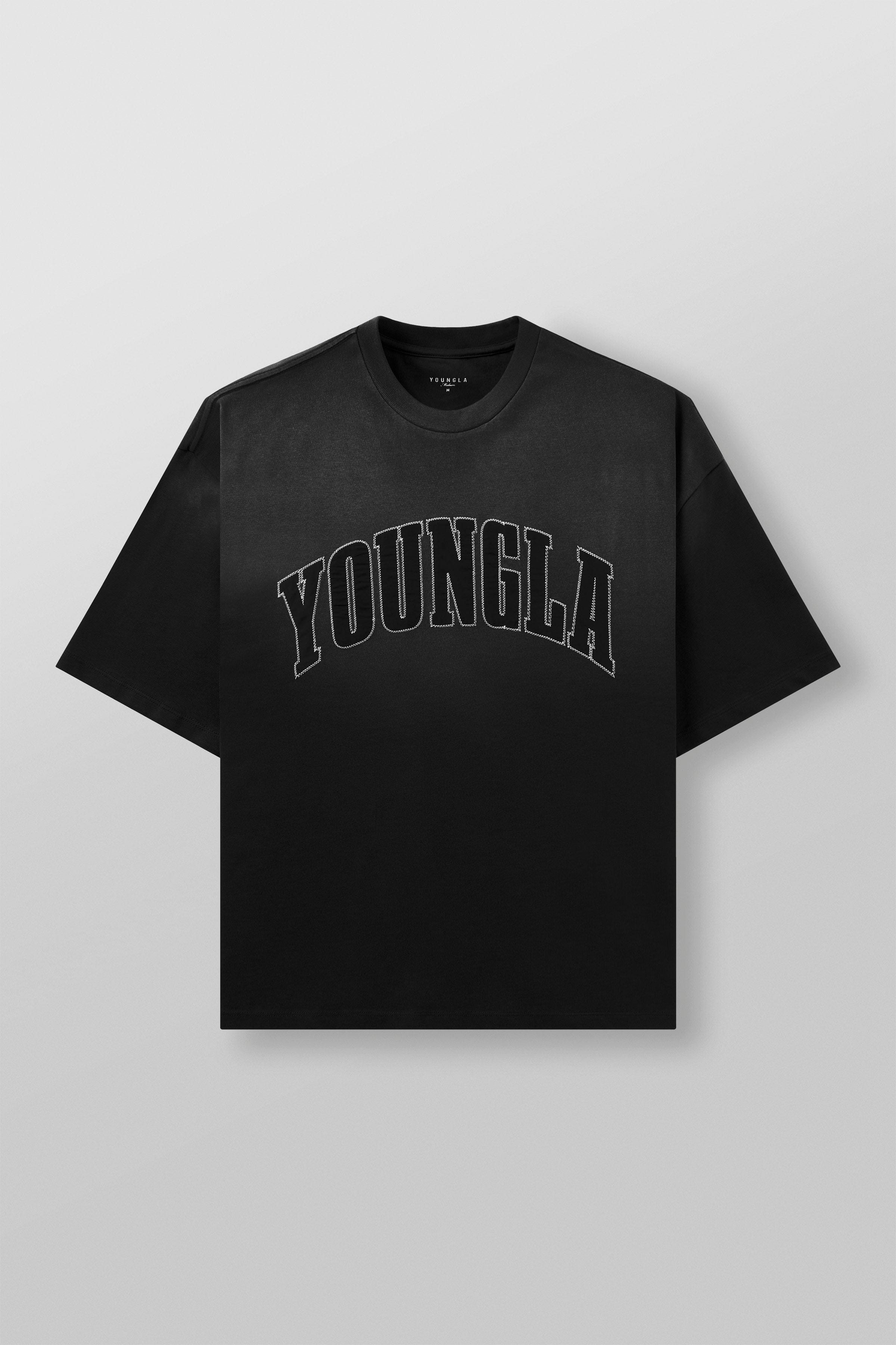Side angle of oversize t shirt with arched logo, worn casually on urban street