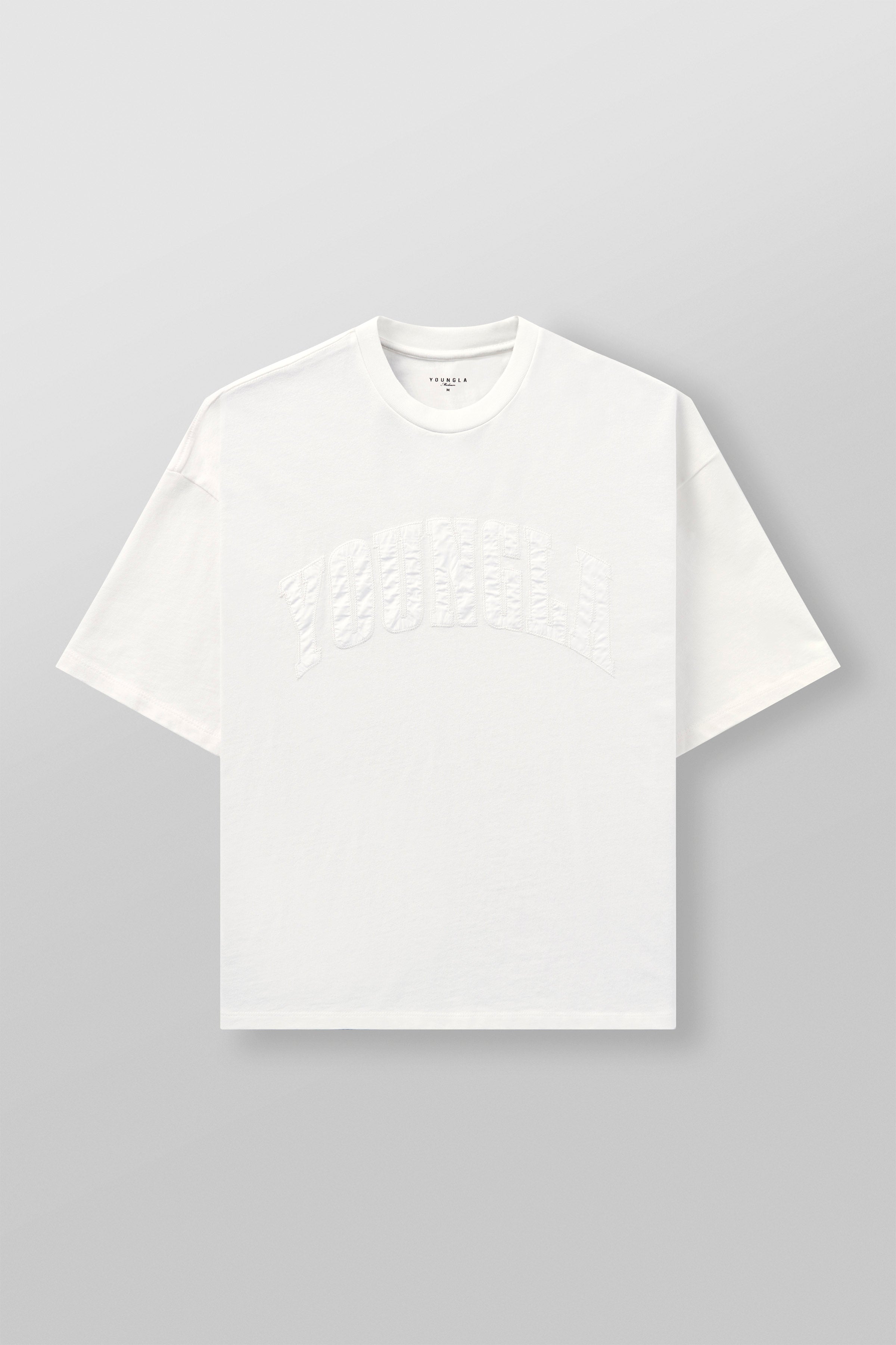 Side angle of oversize t shirt with arched logo, worn casually on urban street