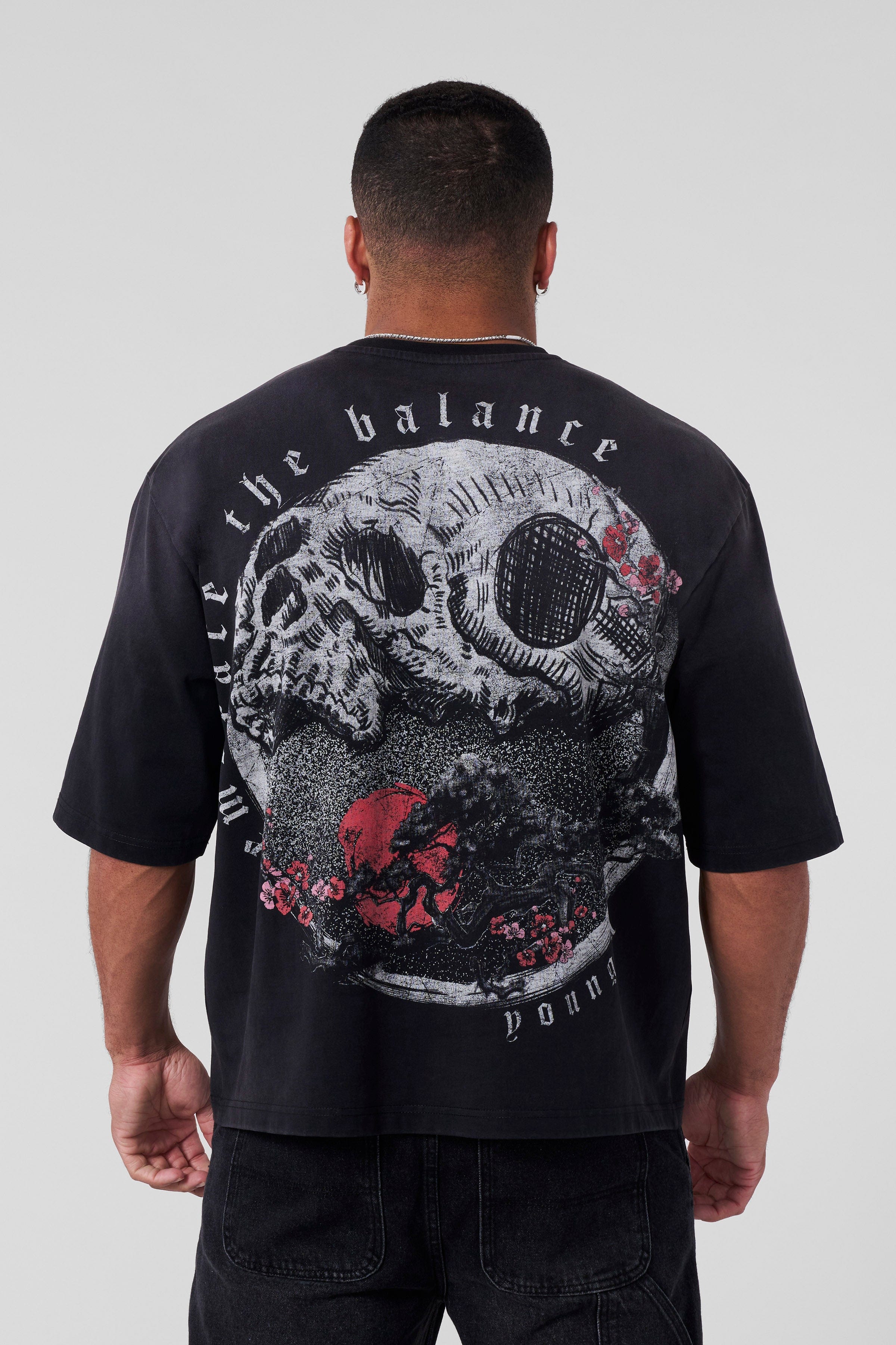 Model wearing Yin Yang Tee facing backward, showcasing graphic tees with symbolic prints