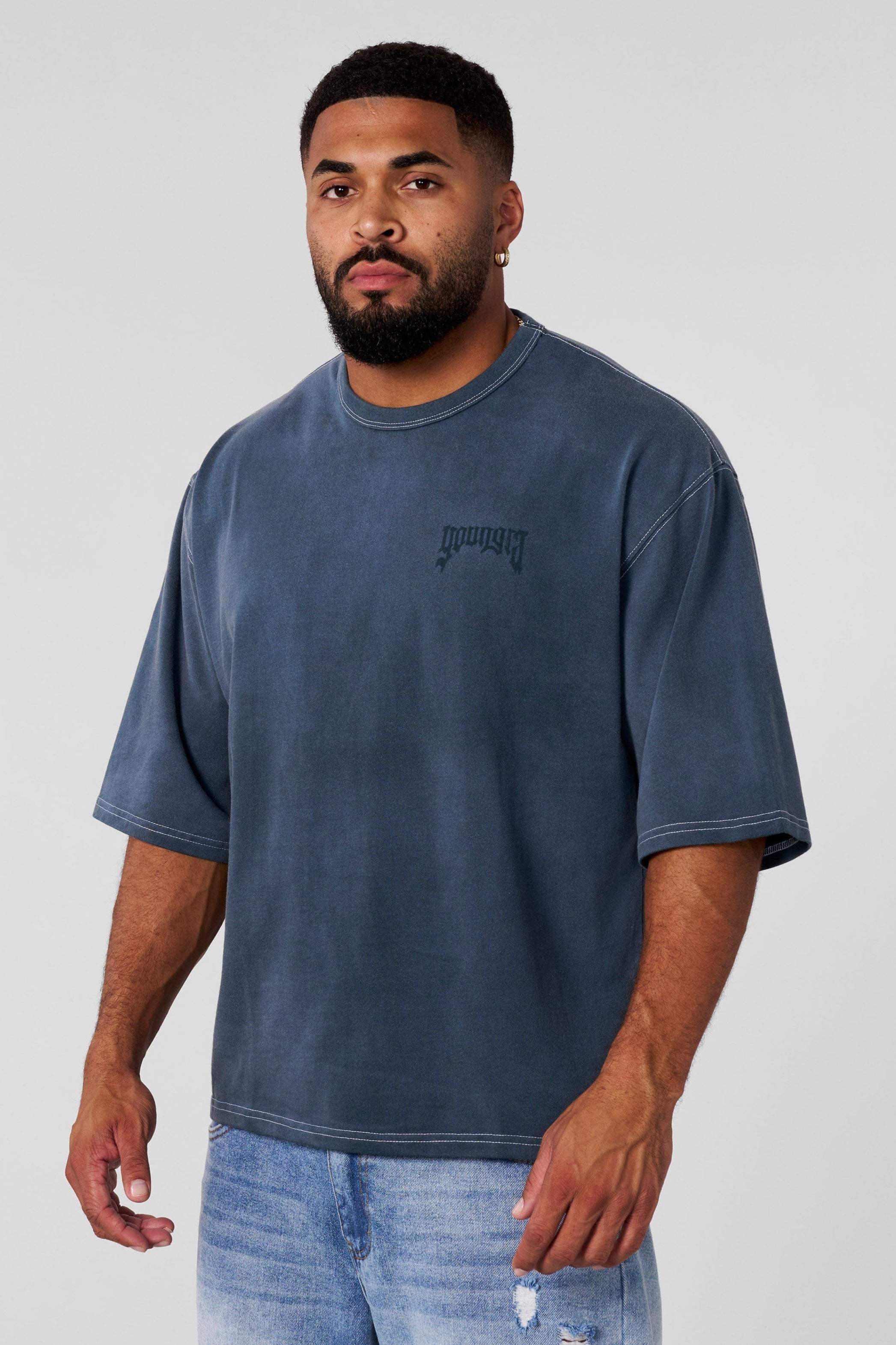 Front view of oversized cotton t shirt with shadow logo on neutral background