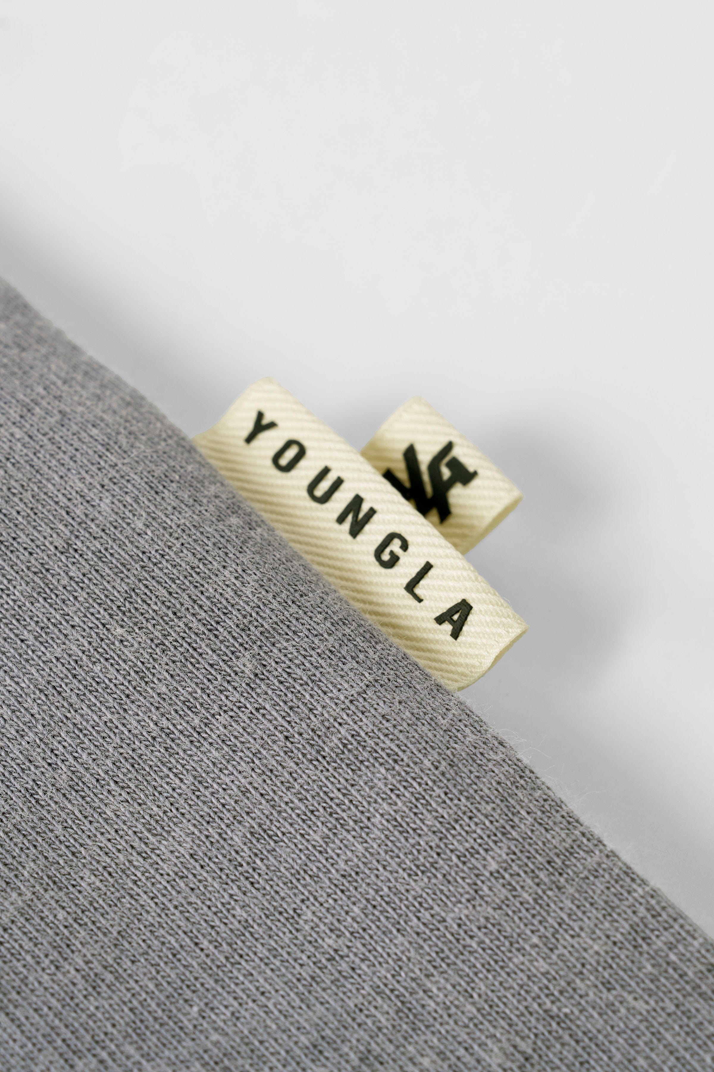Close-up of washed cotton fabric and shadow logo detail