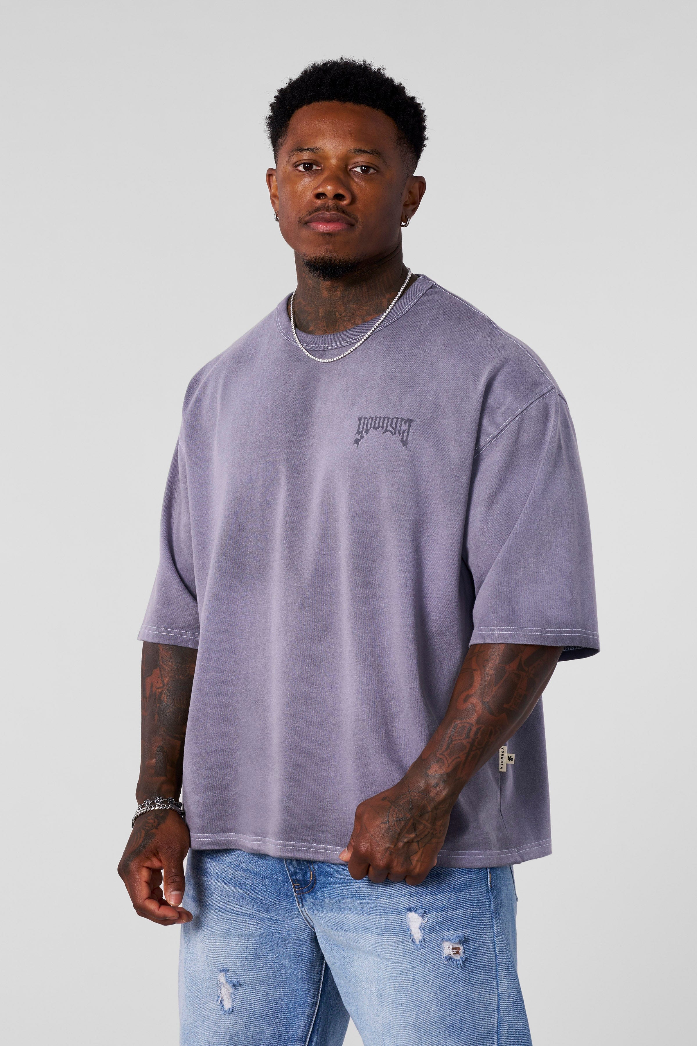 Front view of oversized cotton t shirt with shadow logo on neutral background