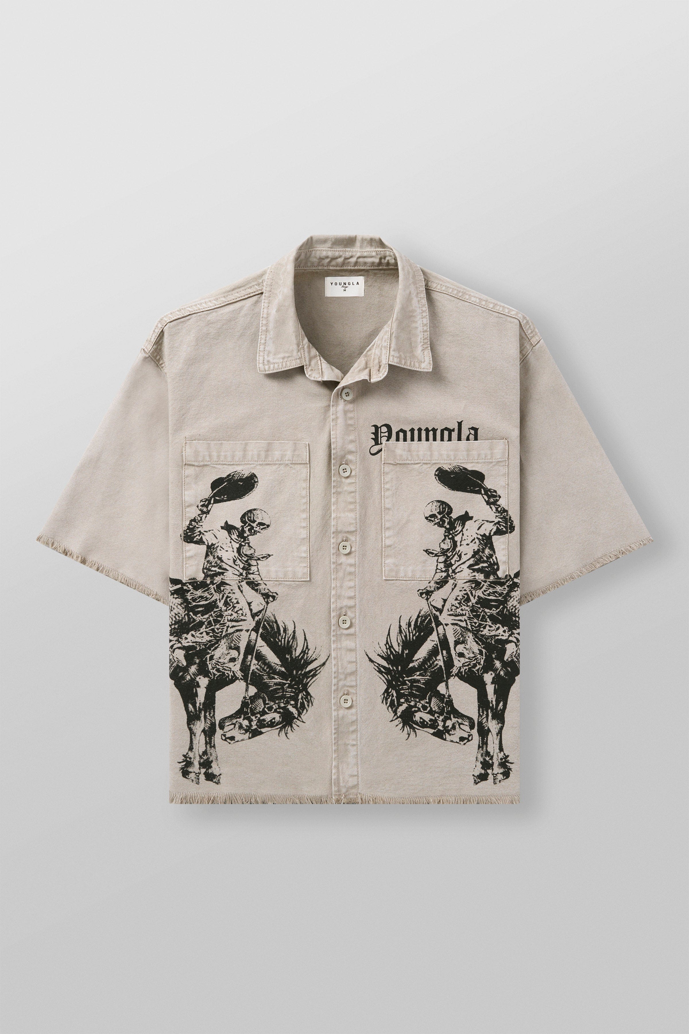 Model wearing western style shirt standing near wooden fence