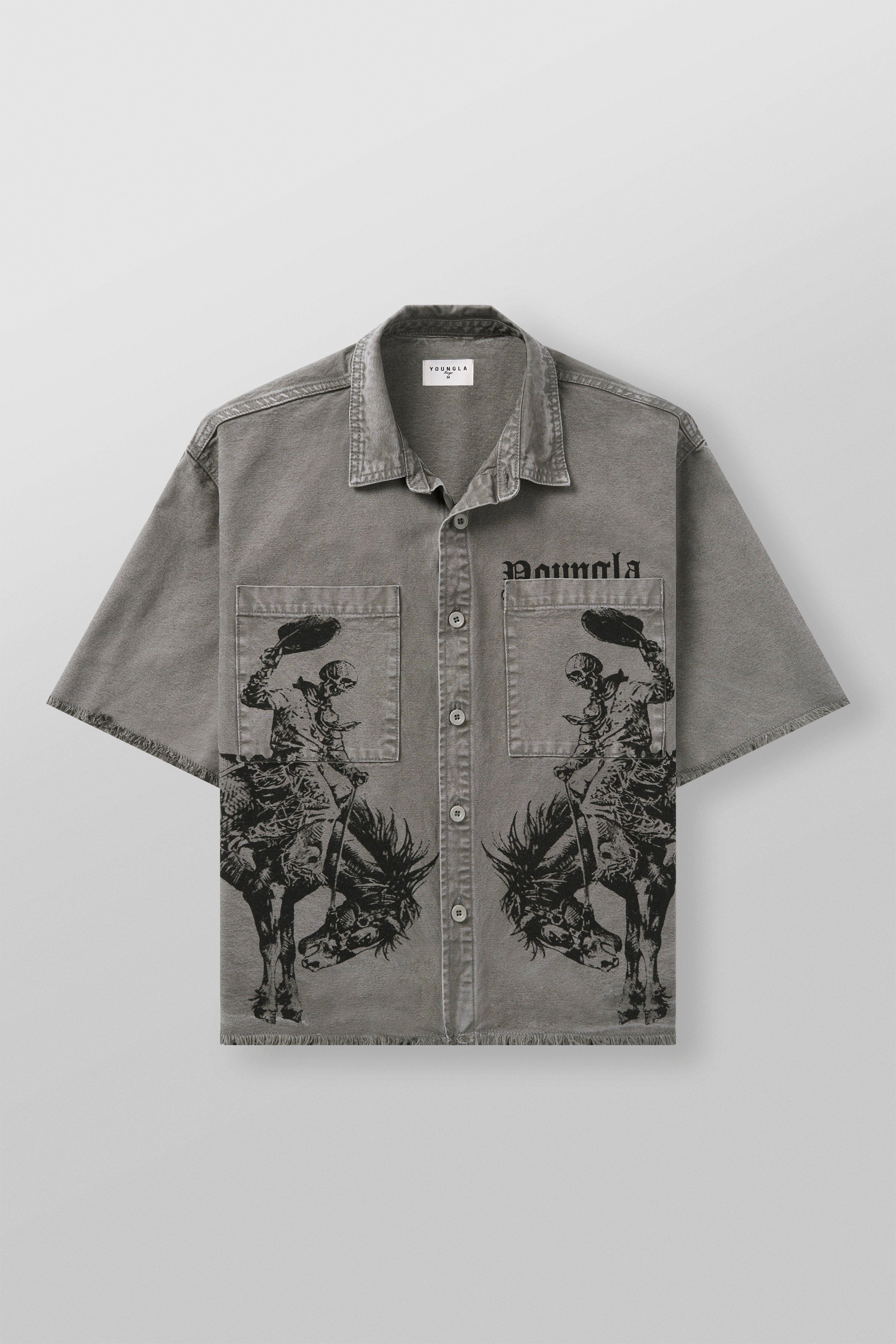 Model wearing western style shirt standing near wooden fence