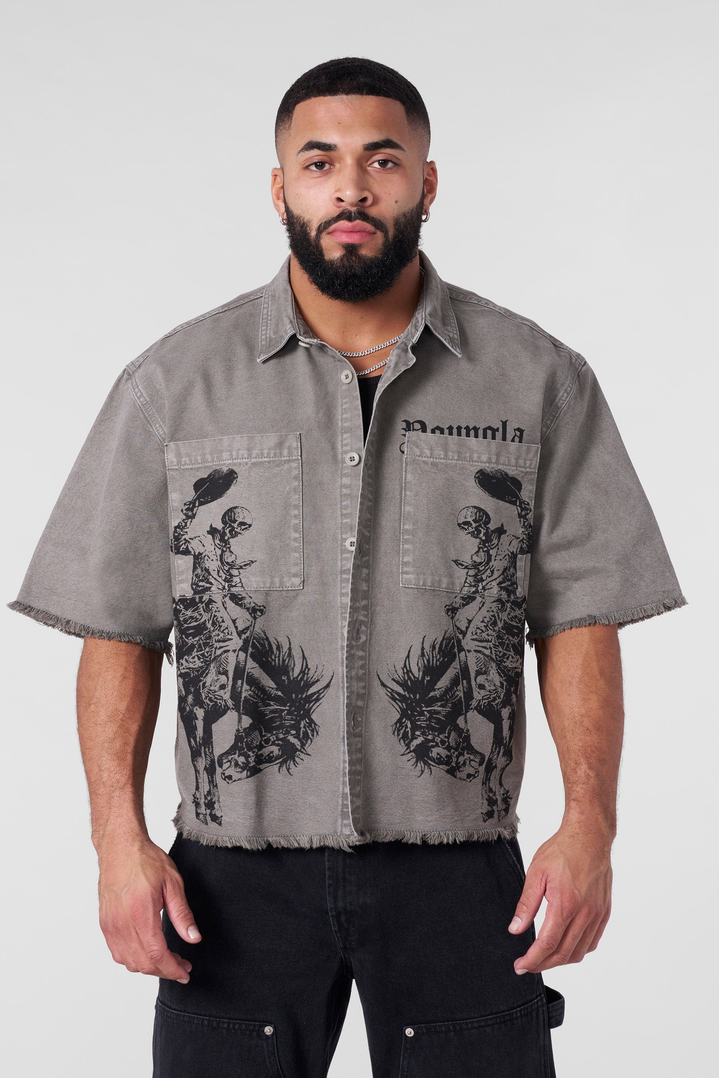 Flat lay showing front and back graphic design of button up shirt