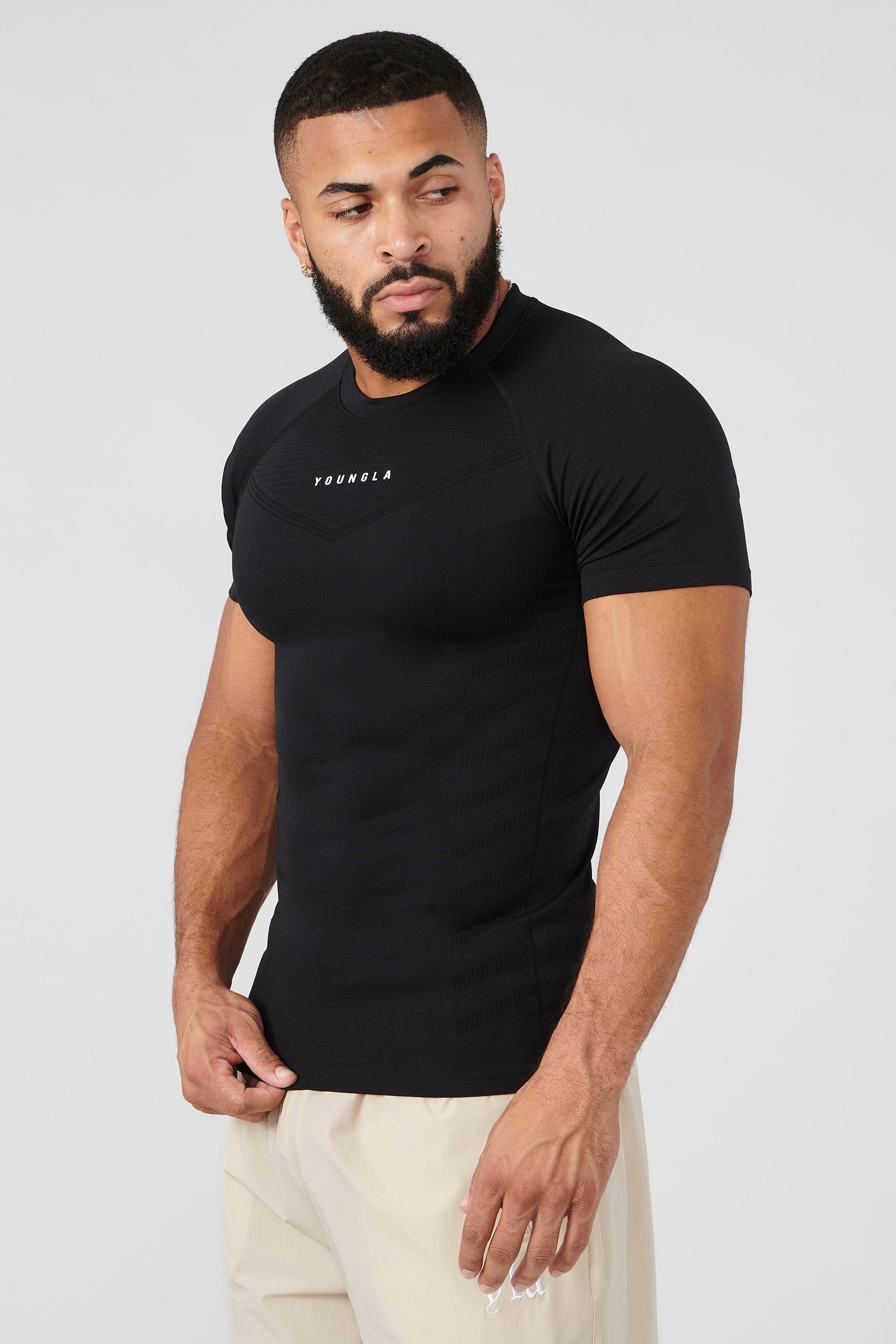 Front view of SuperVillain compression shirt on a man lifting weights.