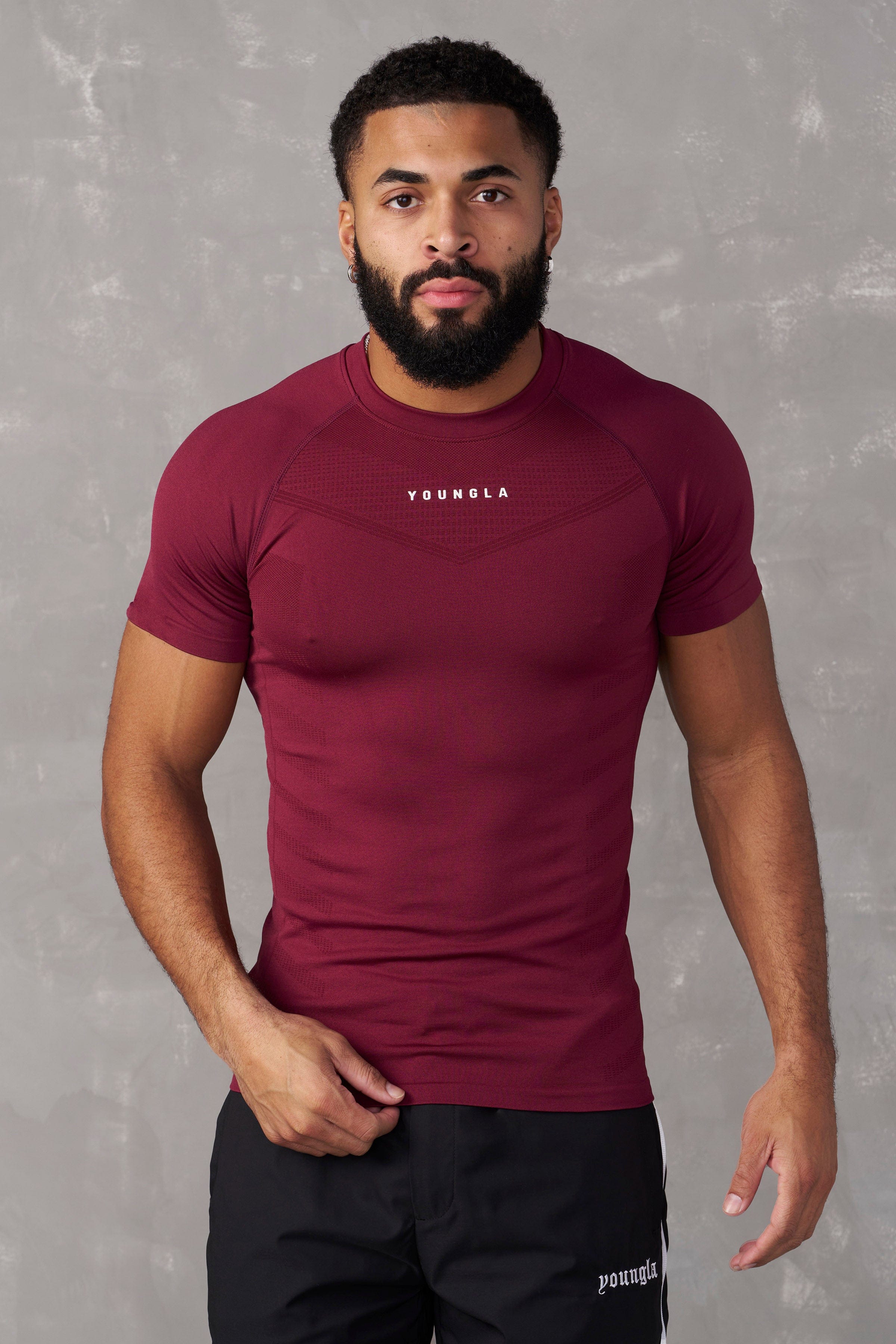 Front view of SuperVillain compression shirt on a man lifting weights.
