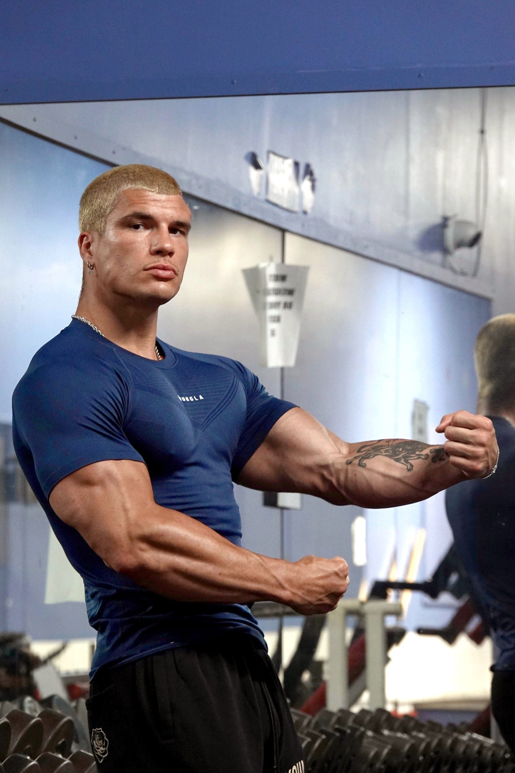 Front view of SuperVillain compression shirt on a man lifting weights.
