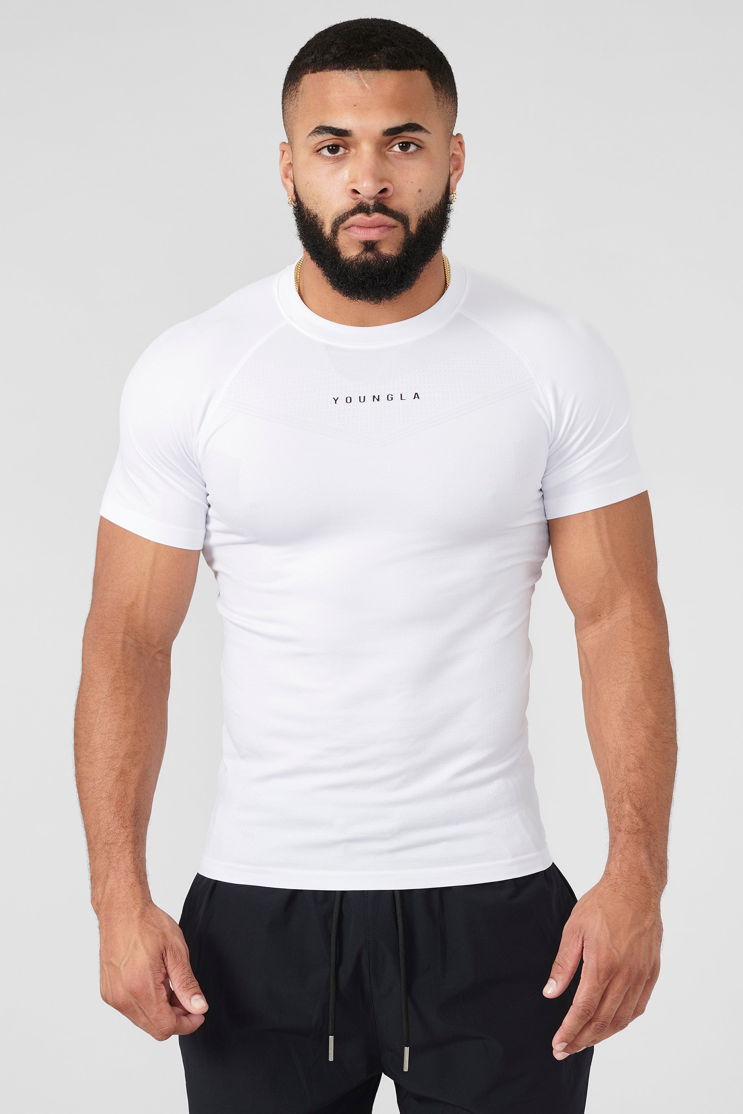 Front view of SuperVillain compression shirt on a man lifting weights.