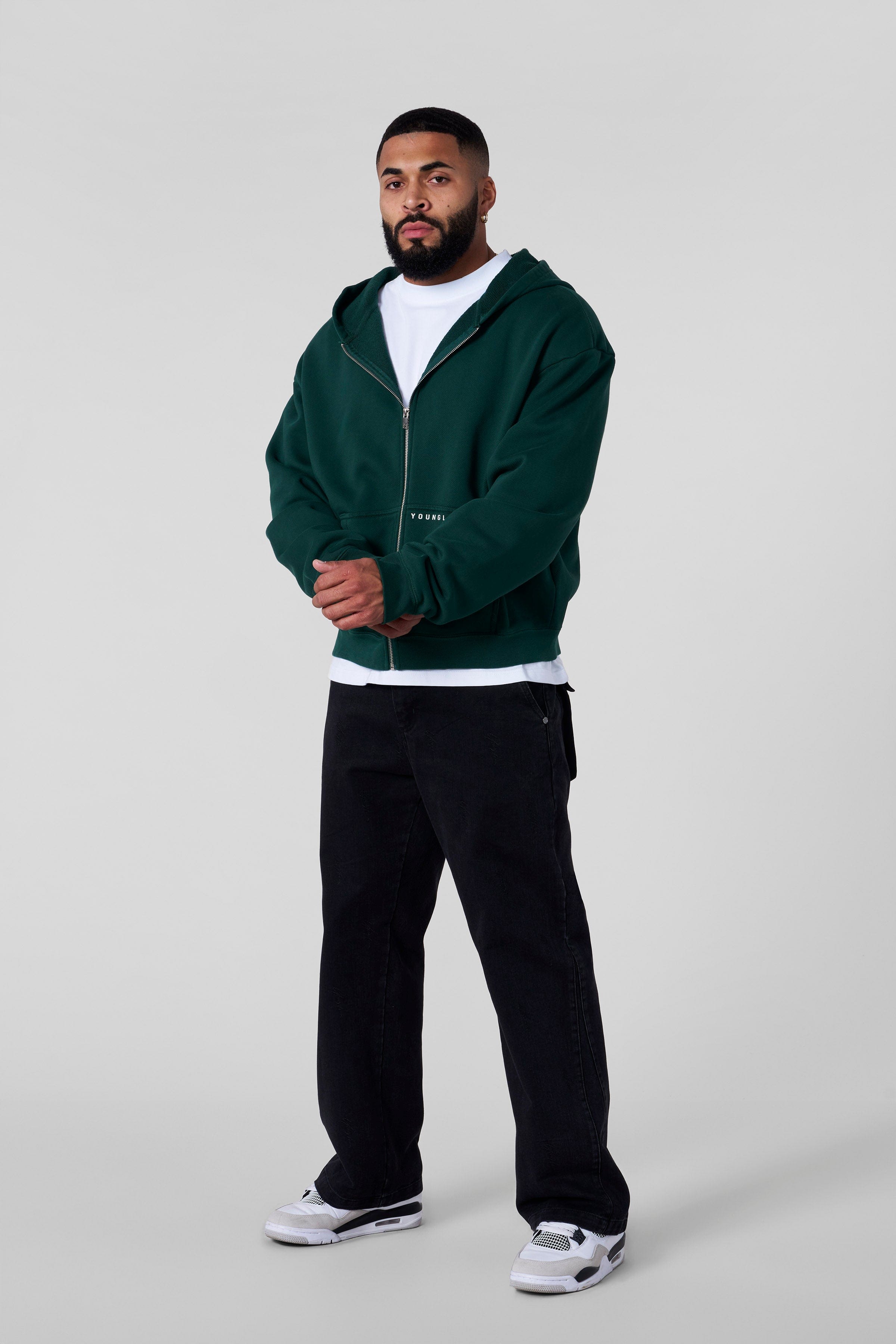 Front view of the Revenge zip-up hoodie highlighting the boxy fit and short length
