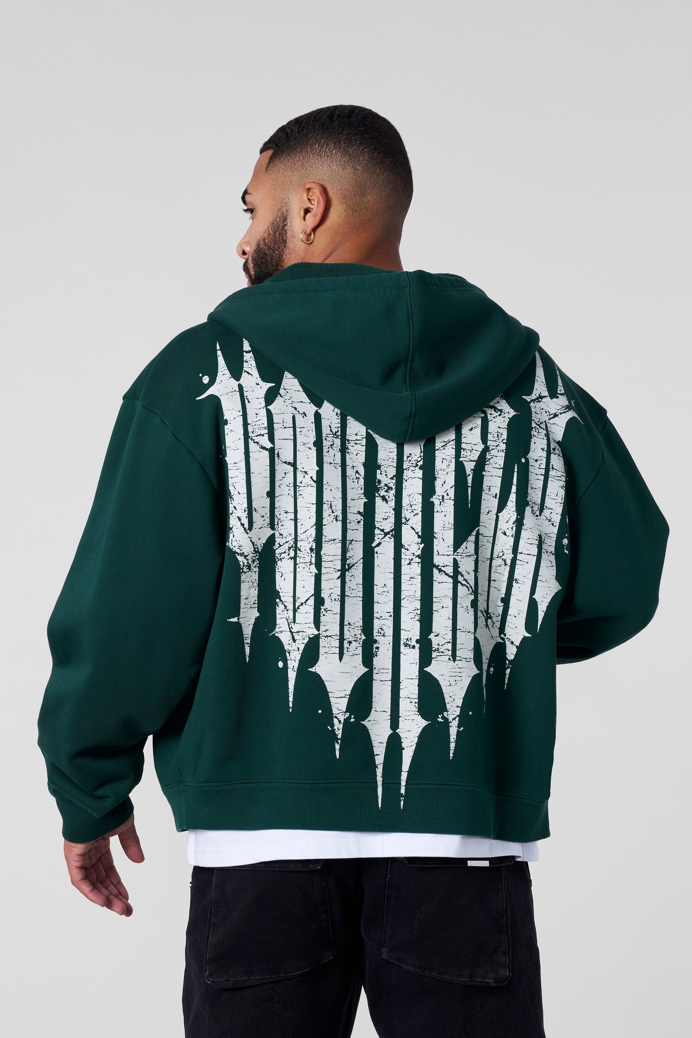 Front view of the Revenge zip-up hoodie highlighting the boxy fit and short length