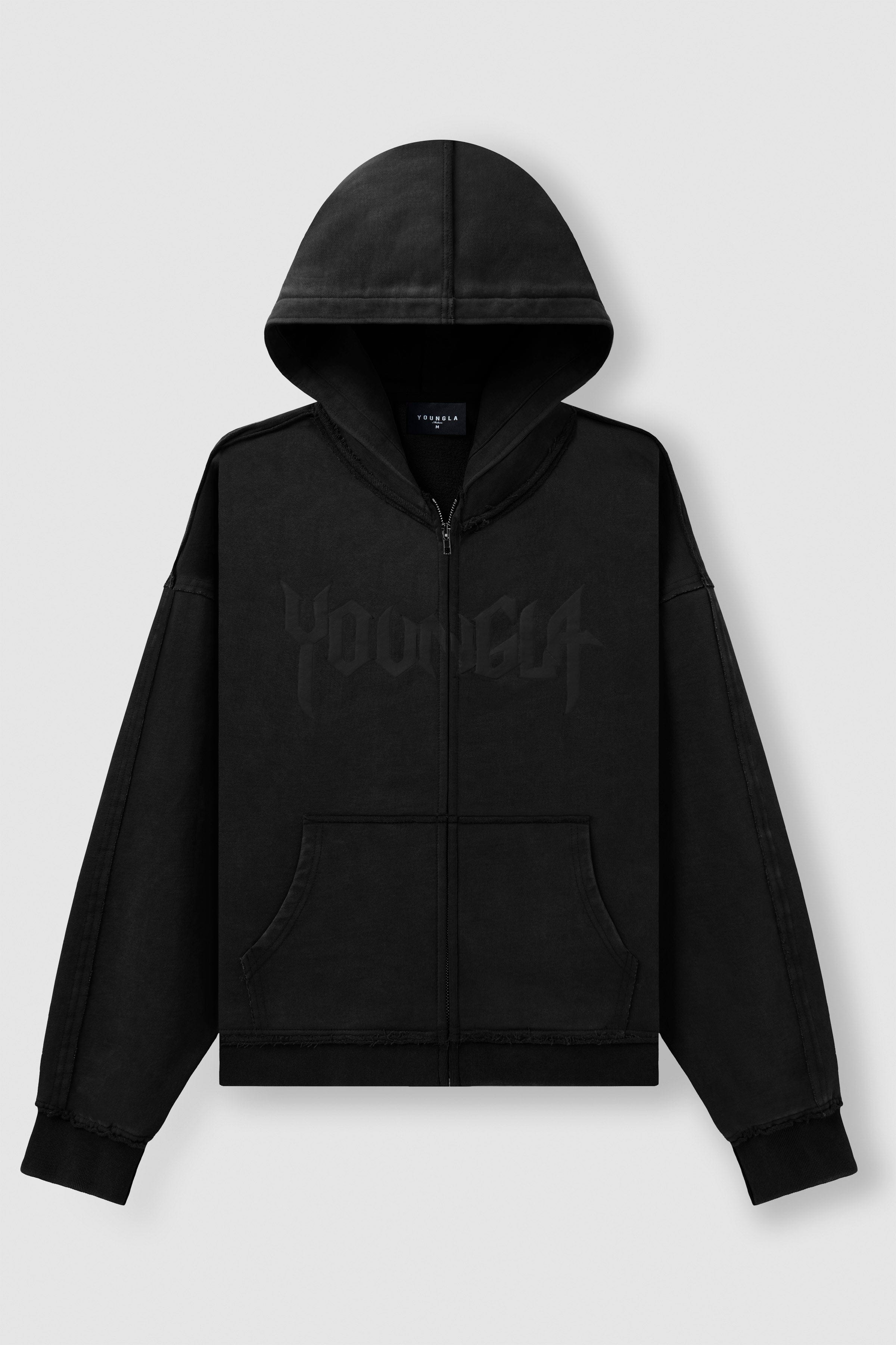 Front angle of black zip up hoodie styled with relaxed jeans.