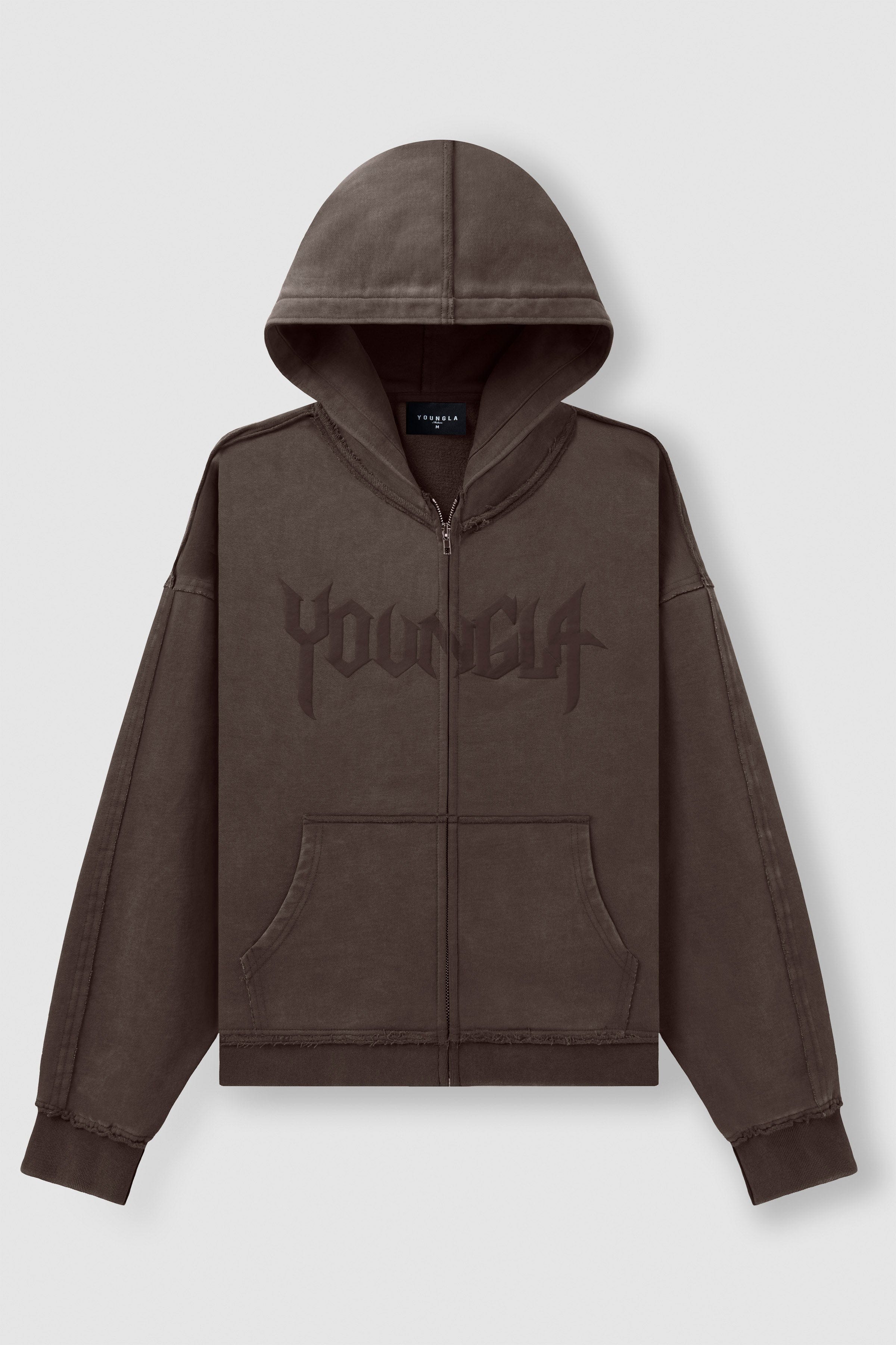 Close-up of chest branding and raw-cut sleeve finish on vintage hoodie.