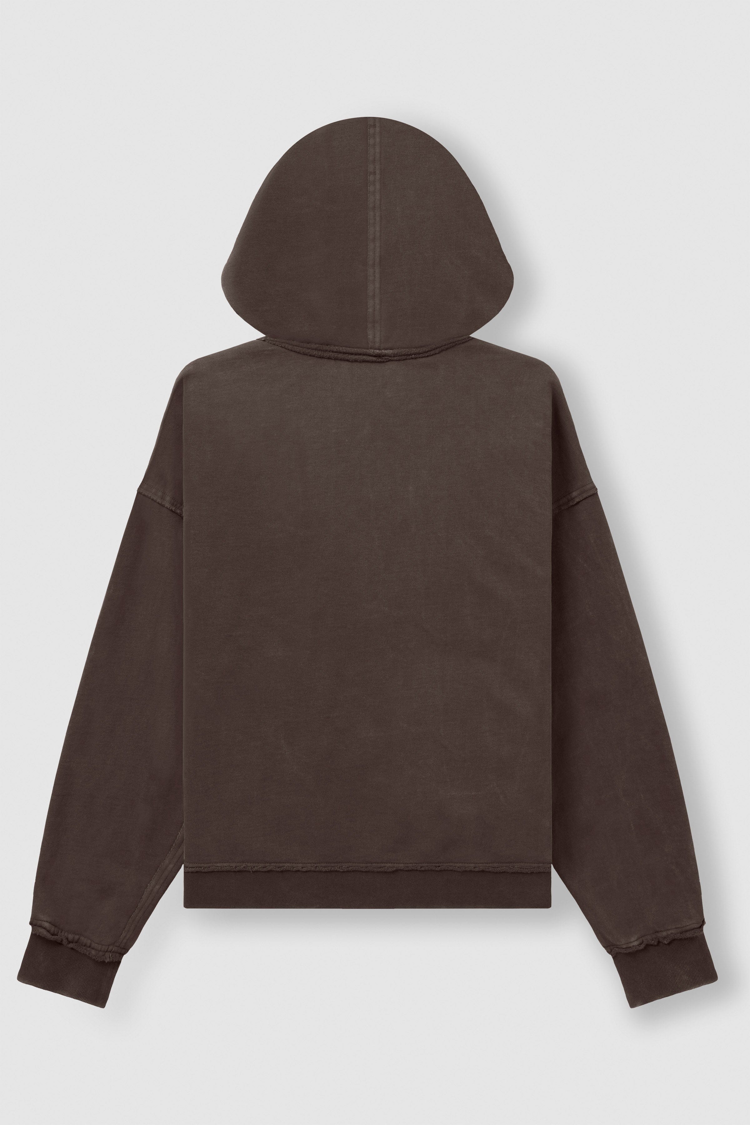 Front angle of black zip up hoodie styled with relaxed jeans.