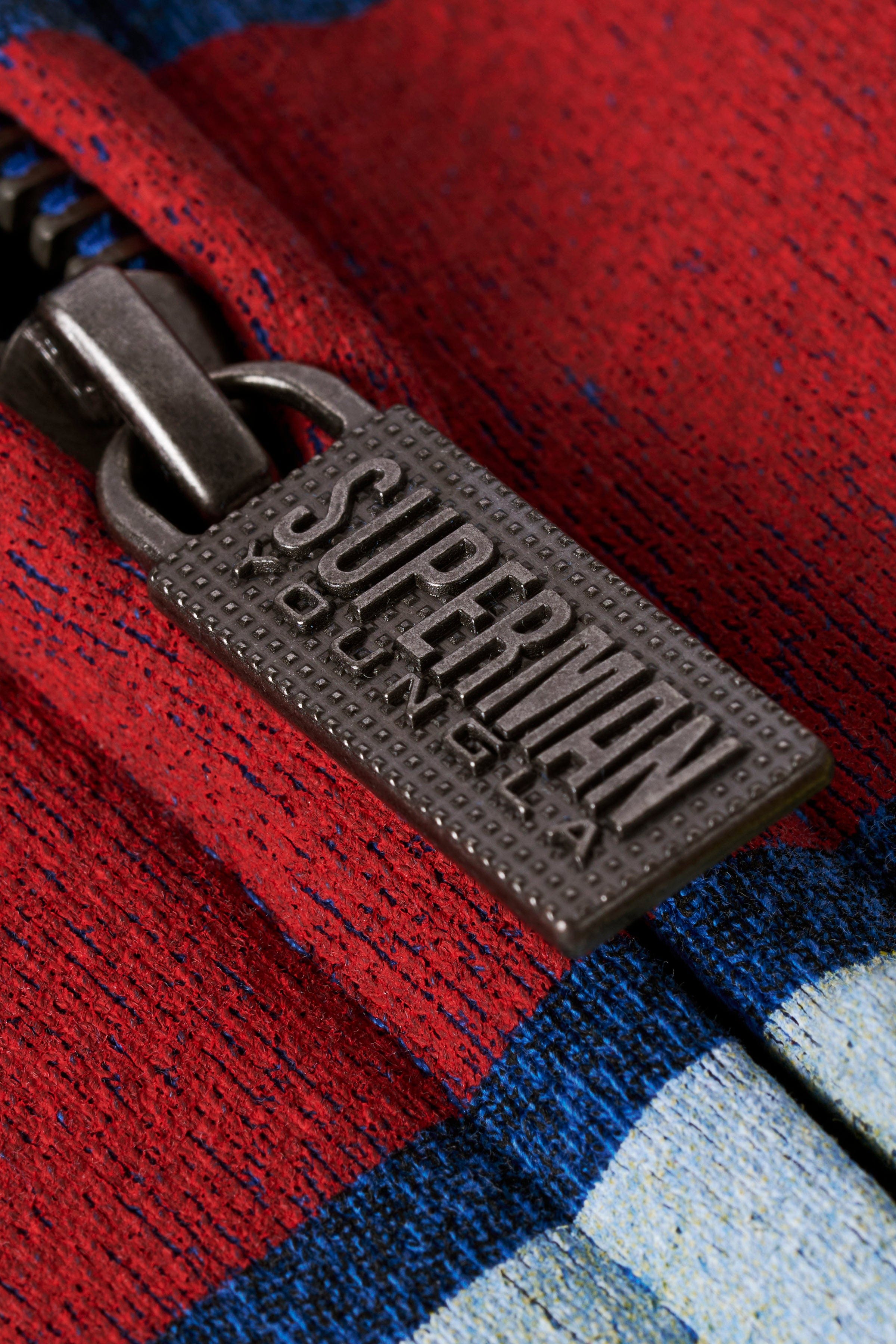 Close-up of the Superman logo on the oversized hoodie, highlighting its vibrant colors.