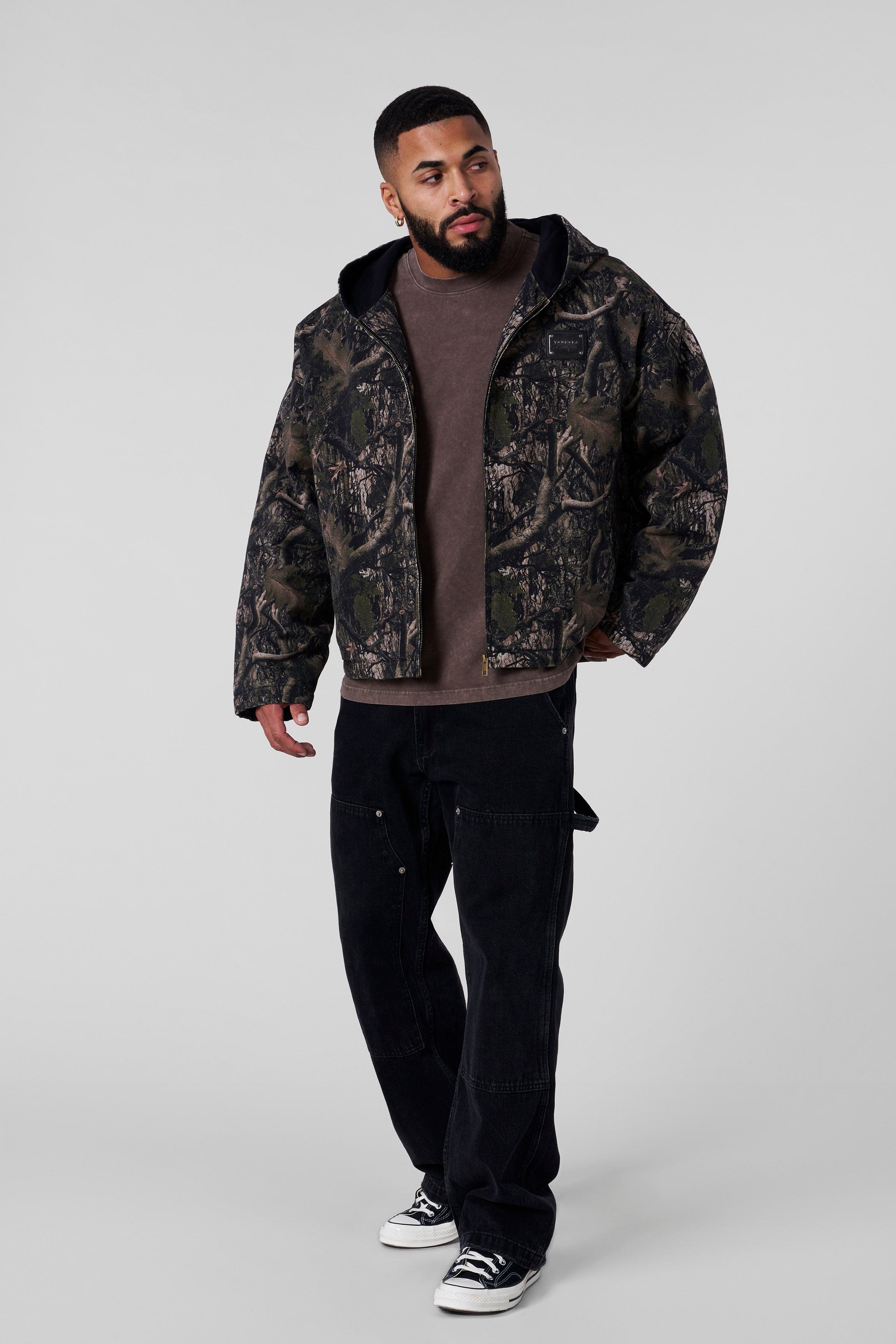 Model wearing the bomber jacket with a neutral background, showcasing fit