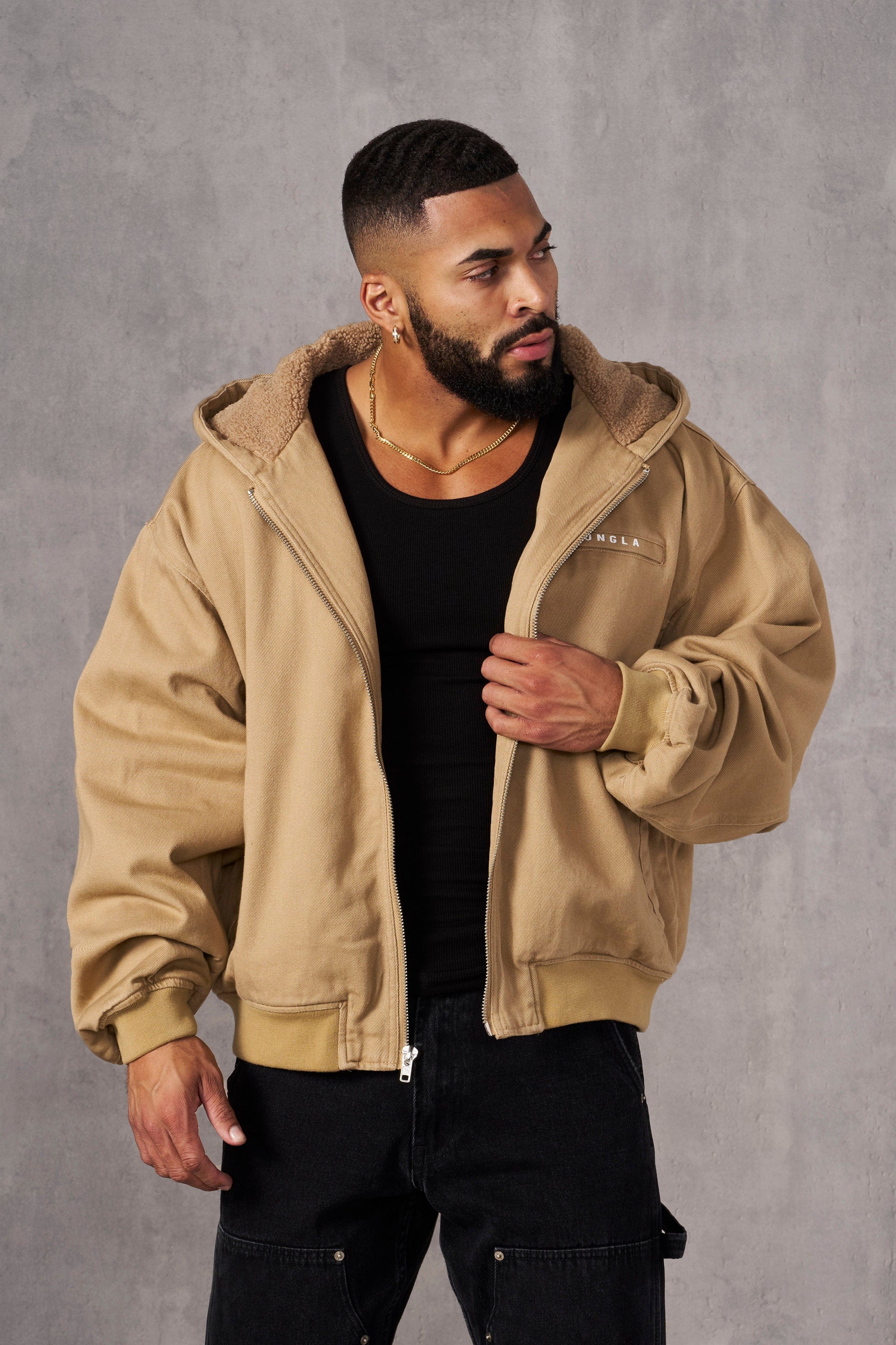Model wearing oversized jean jacket with sherpa lining in urban setting