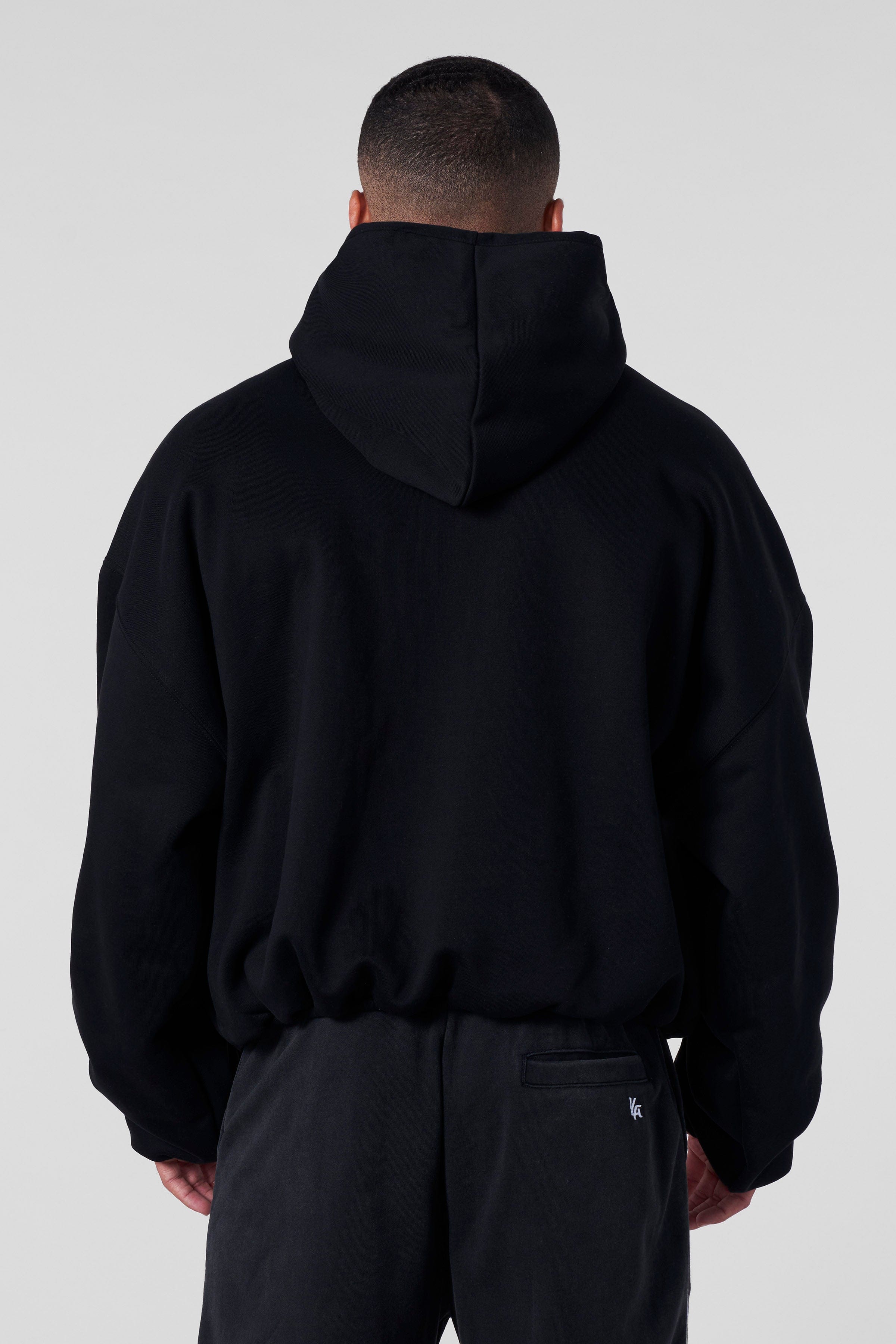 Close-up of minimal logo branding on the SphereFit streetwear hoodie chest