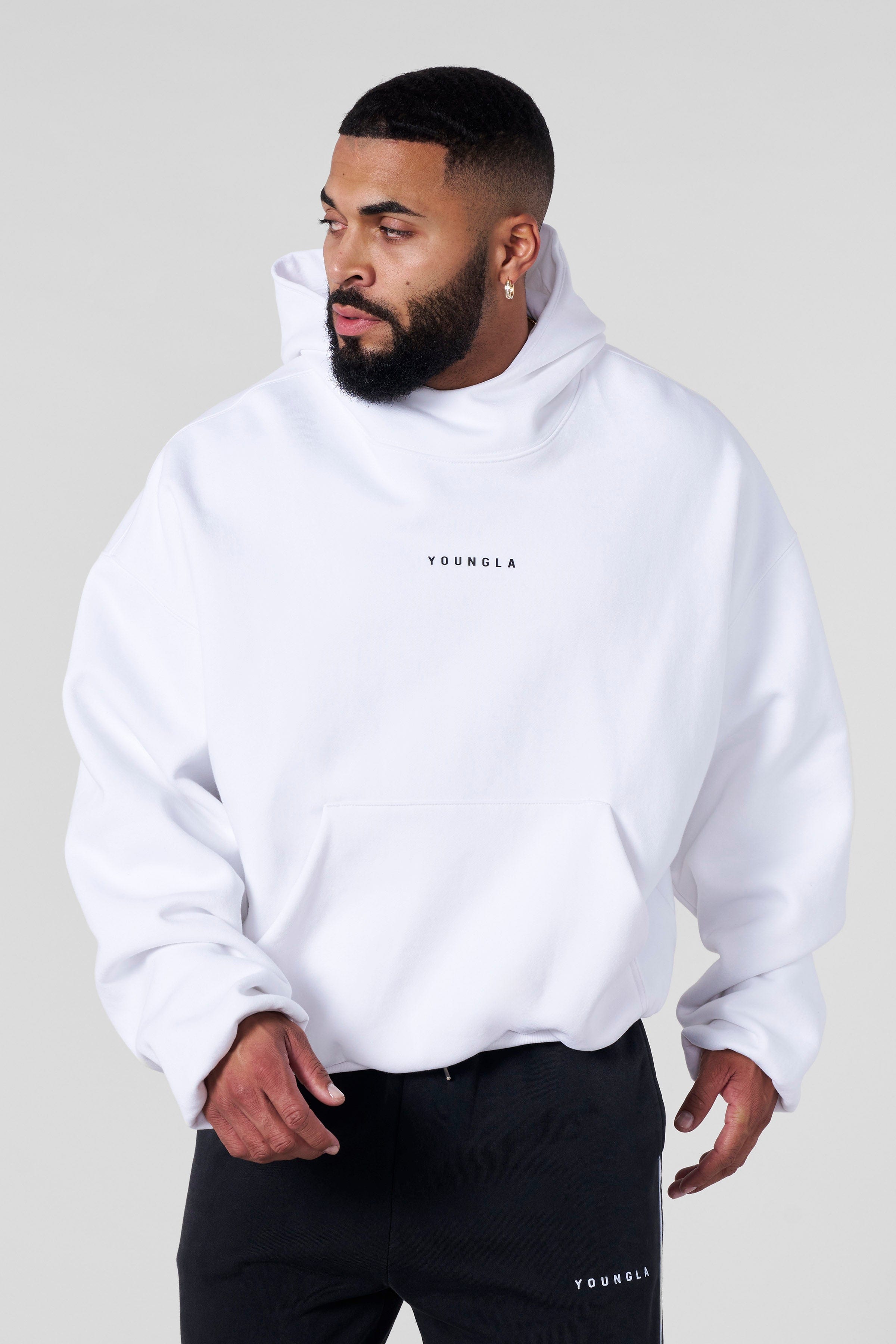 Front view of SphereFit oversized hoodie worn by male model in city backdrop