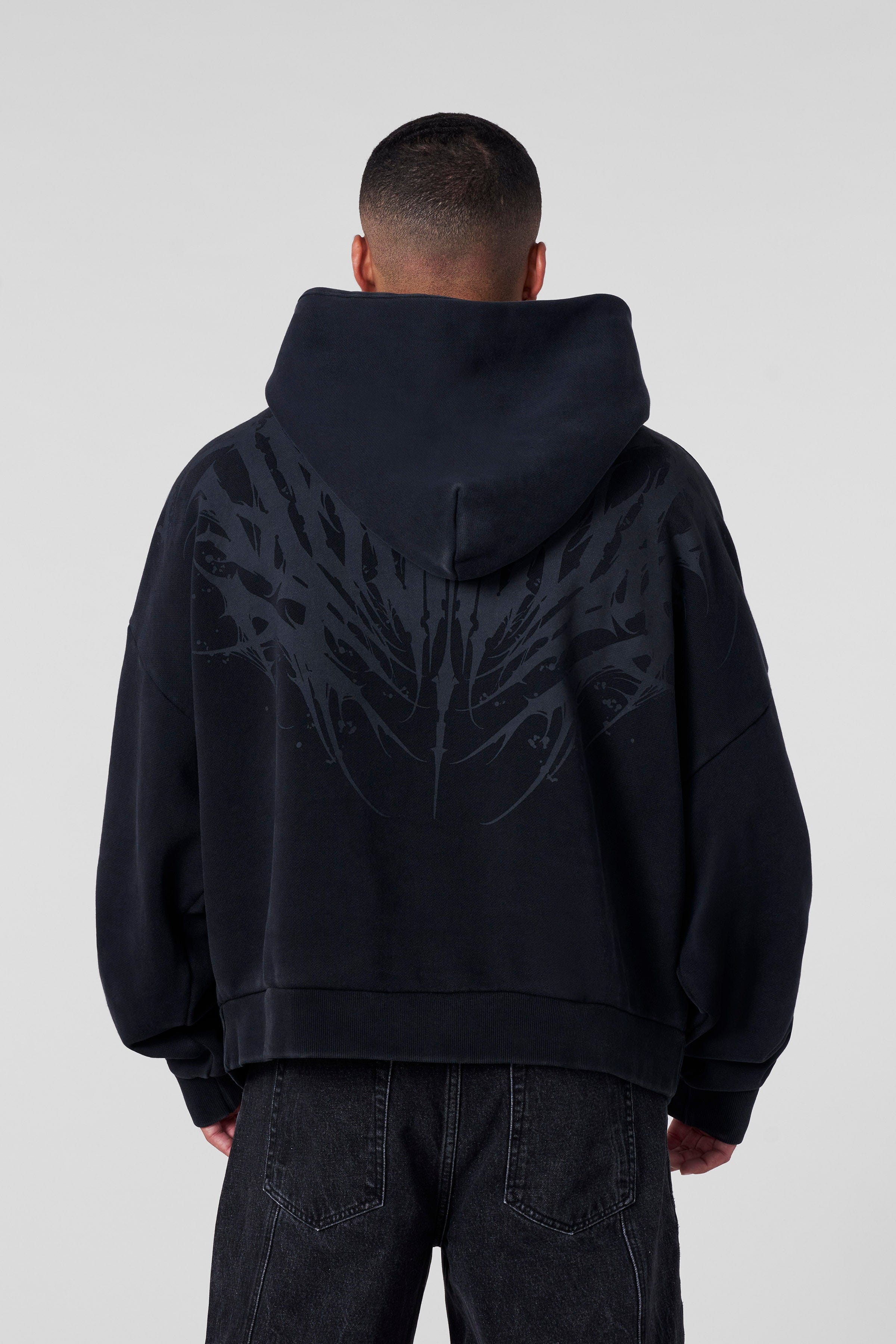 Front view of the oversized zip-up hoodie in a casual setting