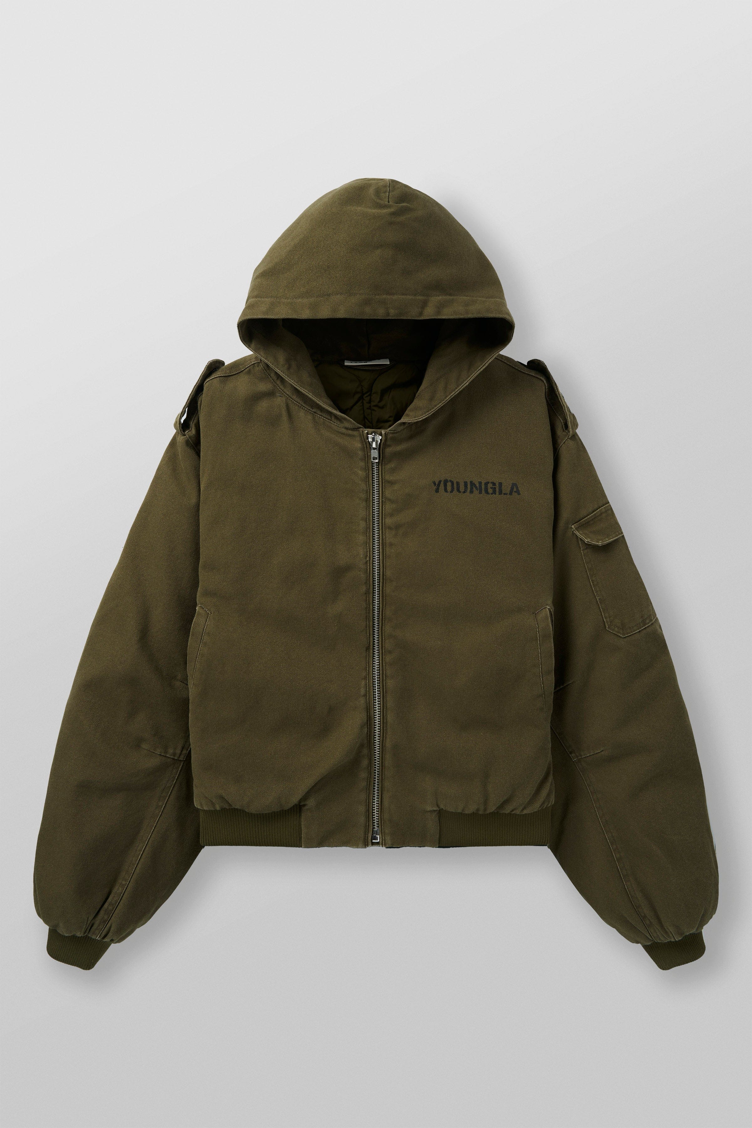 Detail shot of military jackets hanging, highlighting fabric texture and lining
