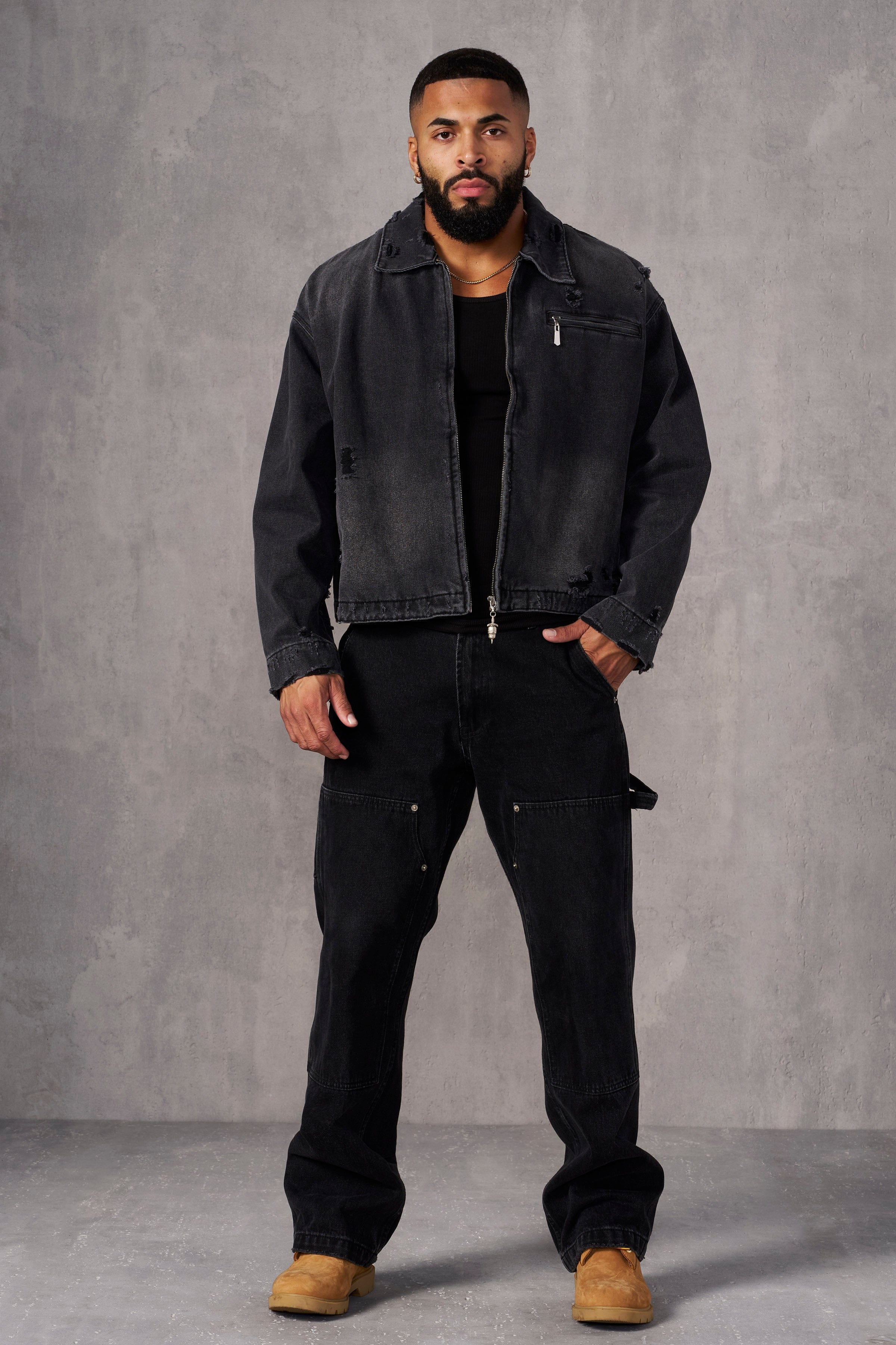 Front view of cropped denim jacket worn by male model outdoors