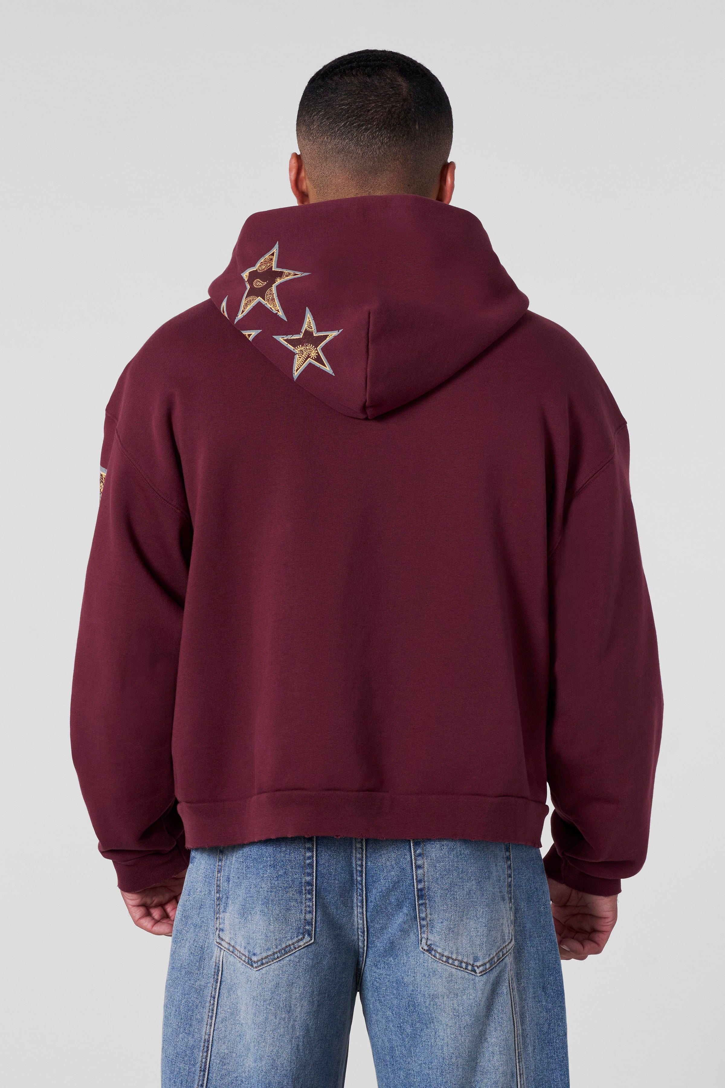 Model wearing the Superstar Comfort Hoodie in an urban setting, perfect for streetwear style.