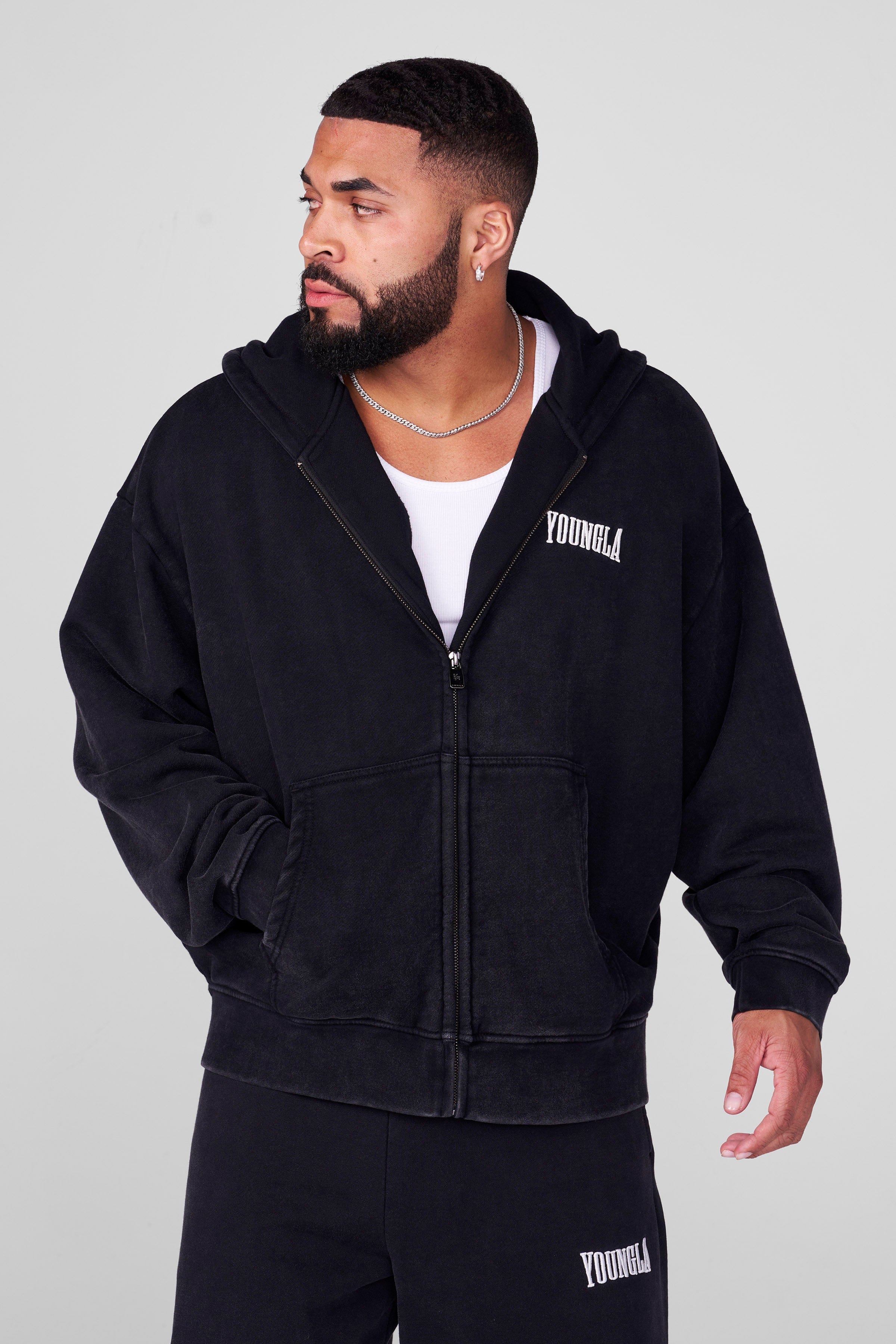 Front view of the grey zip-up hoodie, highlighting its loose fit and zip design.
