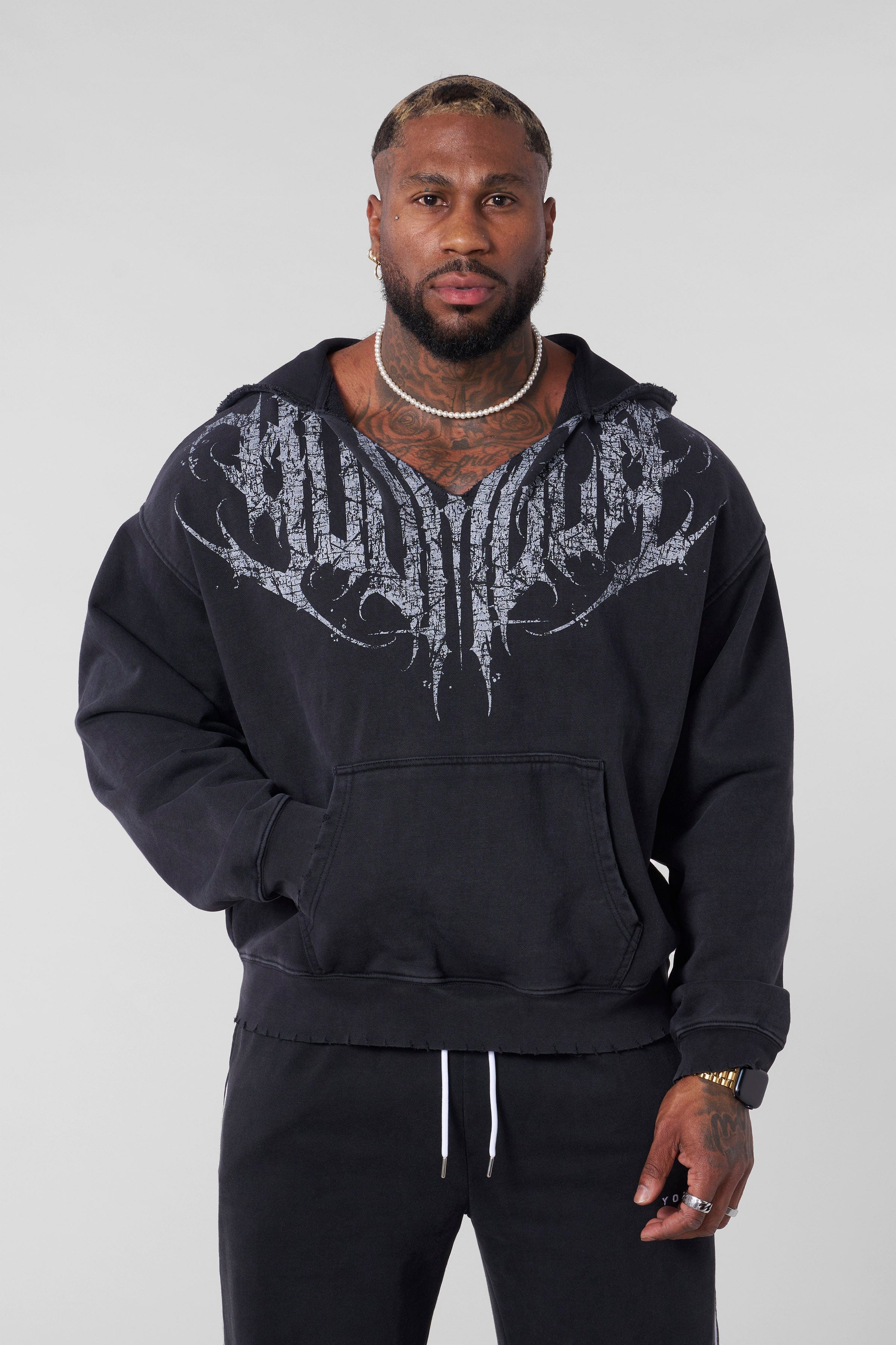 Model wearing a relaxed fit streetwear zip up hoodie outdoors