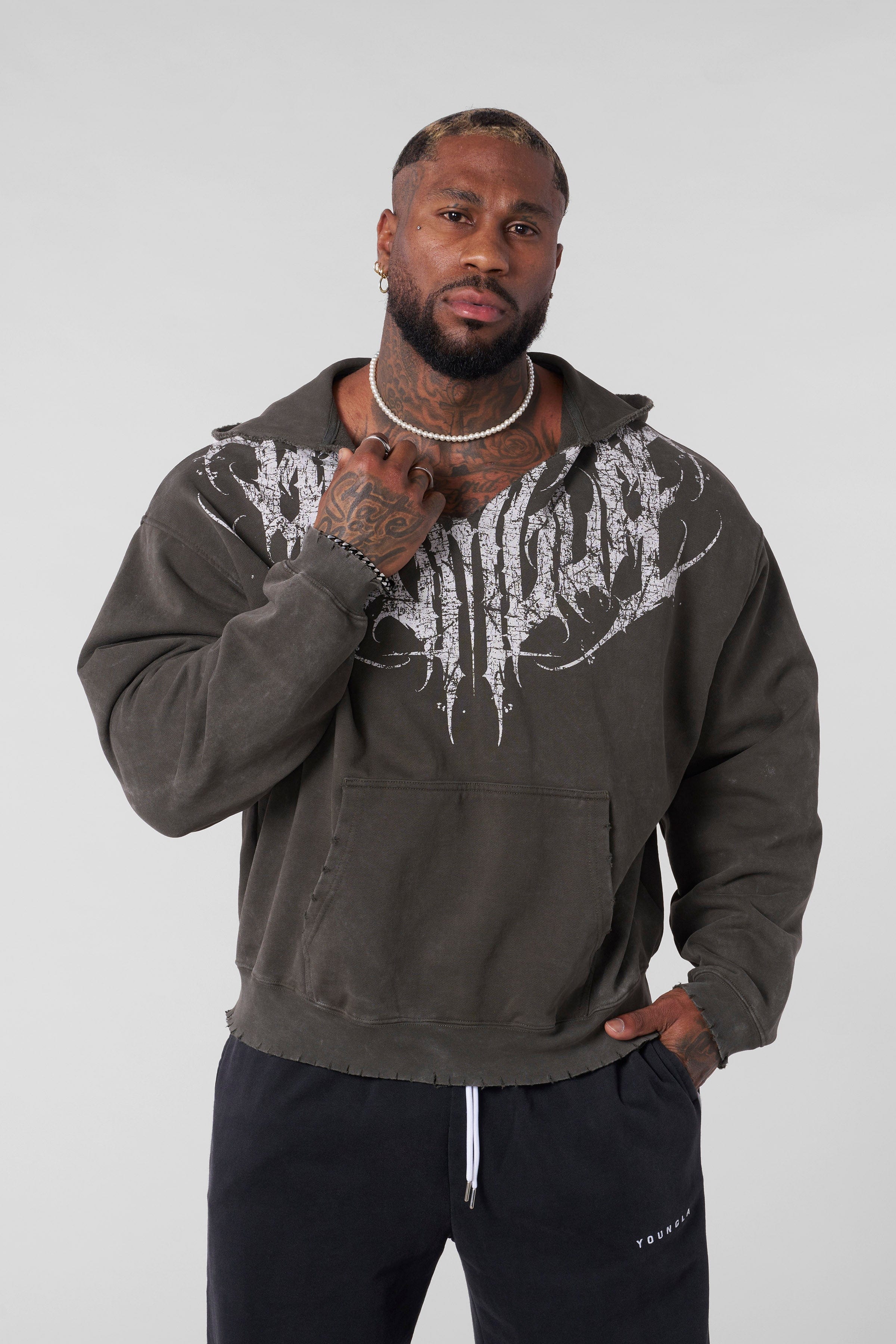 Close-up of raw-cut hood and textured fabric of the distressed hoodie