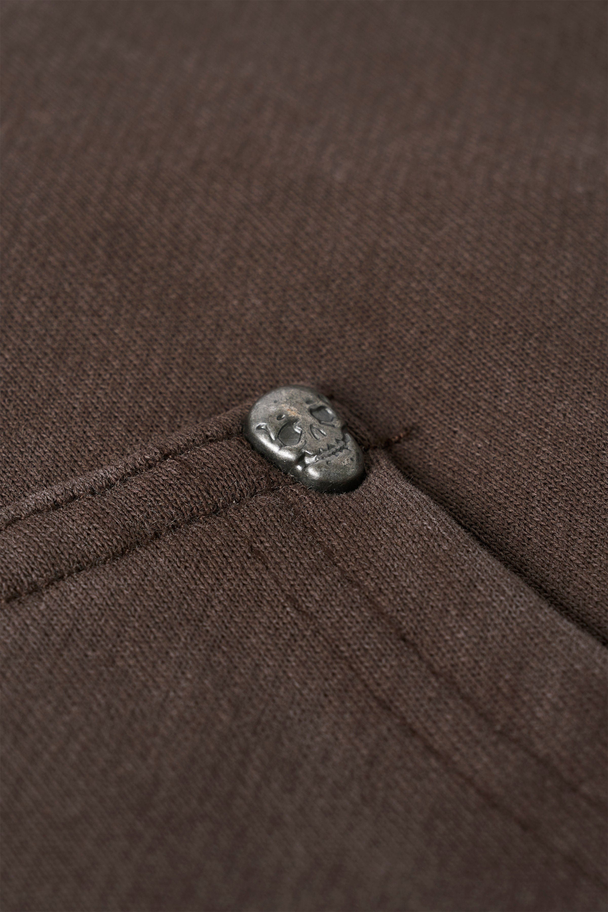 Side view of graphic sweatpants showcasing skull and floral designs.